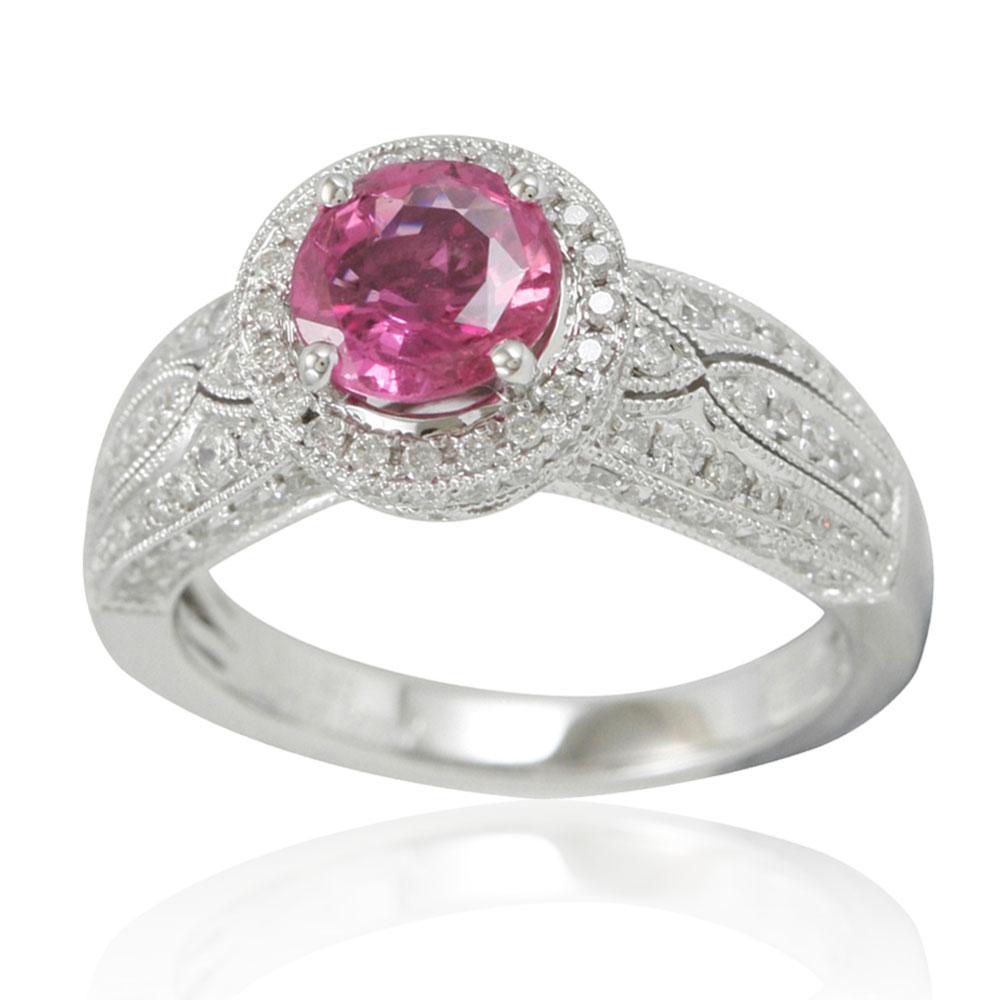 This spectacular cocktail cluster style ring from the Suzy Levian limited edition collection features a large ceylon pink sapphire center held in a 14K white gold prong setting. An array of 120 smaller white diamonds (.95cttw) with hand-carved