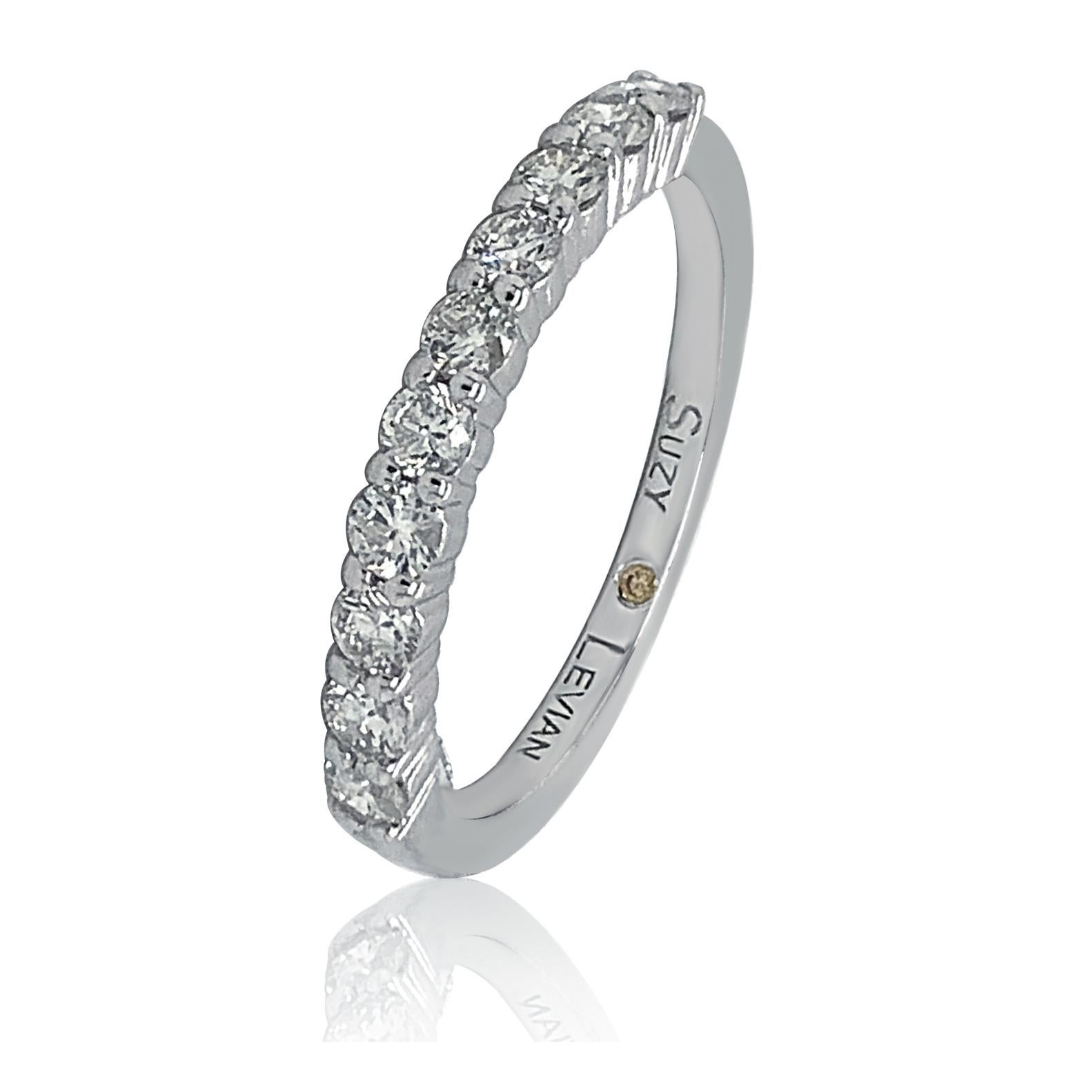 This elegant Suzy Levian diamond half eternity band features a total of ten round cut diamonds (G-H, S1-S2). The diamonds sparkle along half the eternity band, for a sparkle you can't miss with a comfort fit. Designed by Suzy Levian. This 14K white