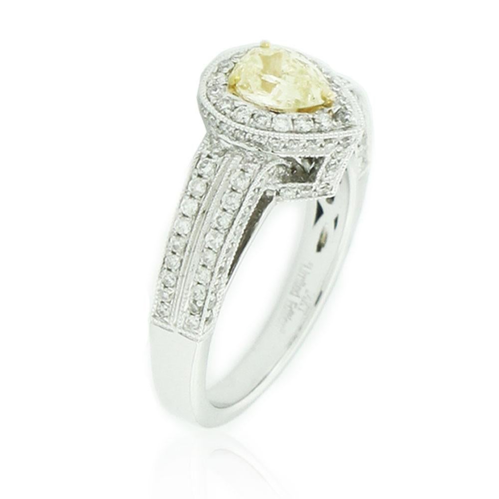 This spectacular ring from the Suzy Levian's limited edition collection features a 14k white gold setting with a pear-cut, yellow diamond center stone (.65ct) . An array of white diamonds (.92cttw) accent the perfect gold setting of the ring. The