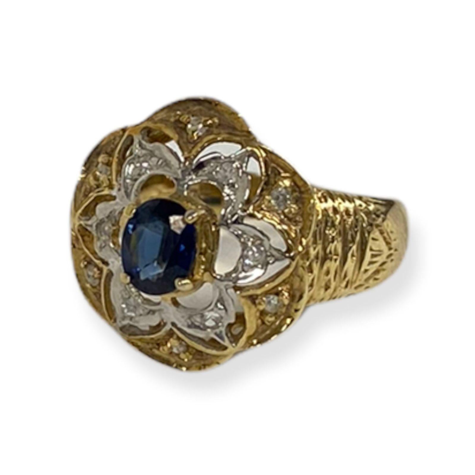 This spectacular ring from the Suzy L. Vintage-Inspired One-of-a-Kind collection features an array of white diamonds (.10cttw) accenting a center, oval-cut, blue sapphire (.25ct) in a 14k yellow gold setting. So intricate in detail and depth, this