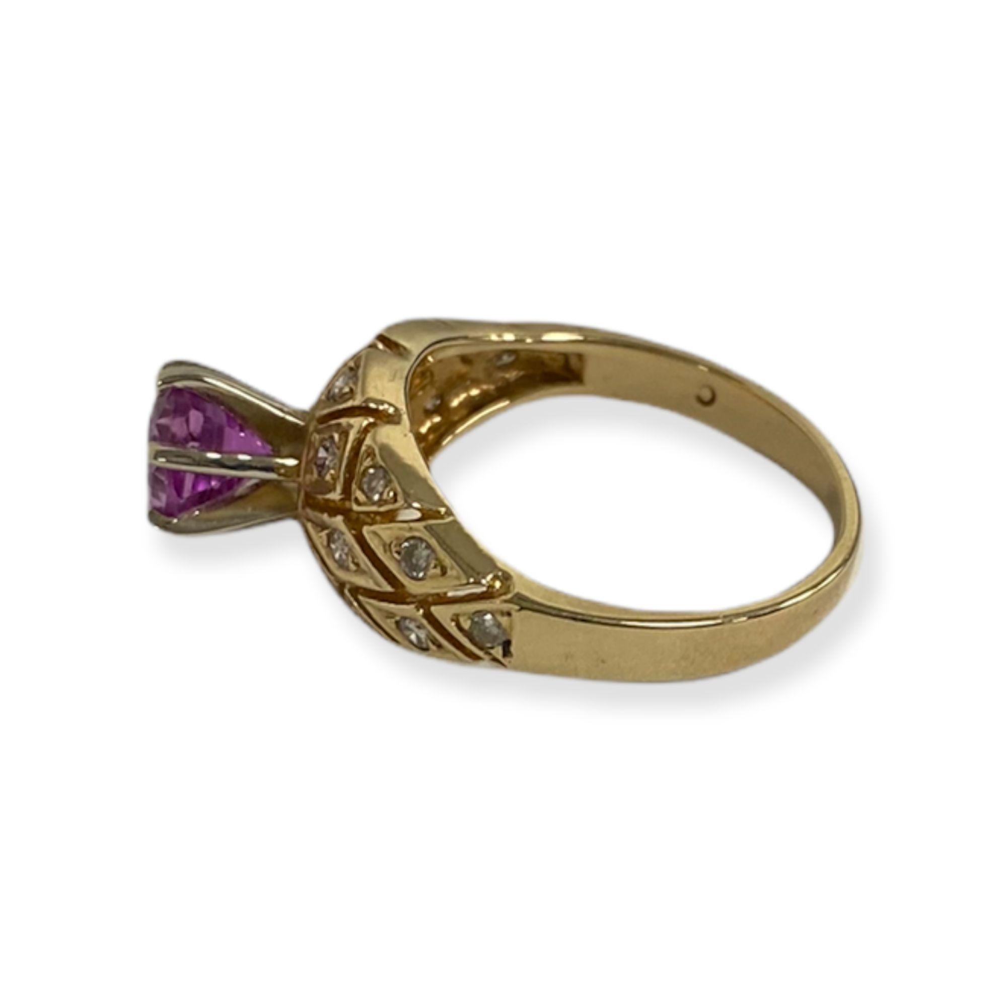 This spectacular ring from the Suzy Levian Vintage-Inspired One-of-a-Kind collection features an array of white diamonds (.20cttw) in a slit-cut 14k yellow gold setting, accenting a center, round-cut, elevated pink sapphire (1.20ct). So intricate in