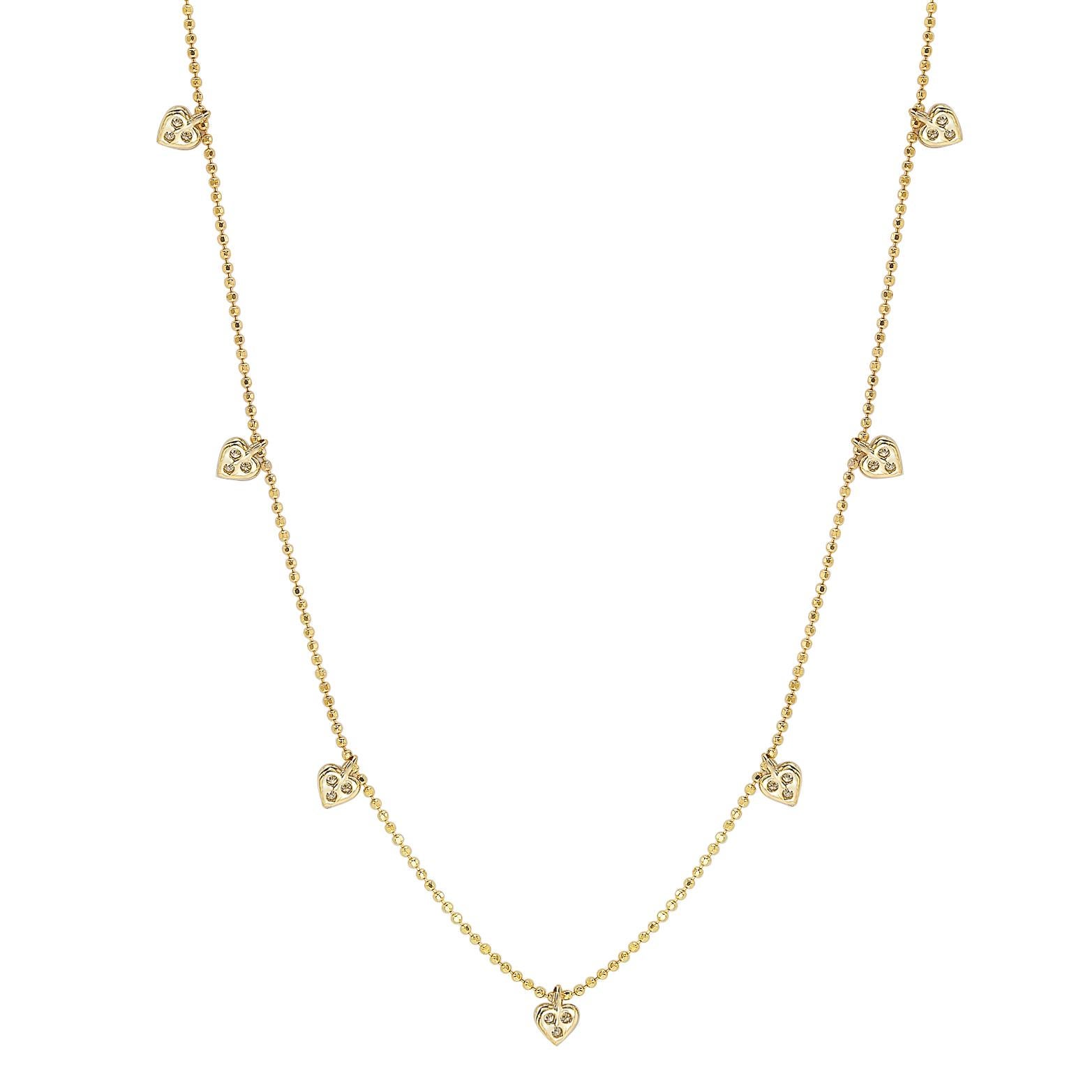 This unique Suzy Levian diamond station heart necklace displays round-cut diamonds on 14 karat yellow gold setting. This gorgeous necklace contains 21 white round cut diamonds totaling .26cttw. The necklace has 7 hearts, each heart contains 3