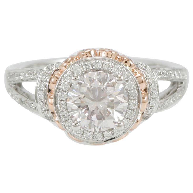 This delicious Suzy Levian ring  features a white diamond center stone (.62 ct) in a 18k two-tone white and rose gold setting. An array of white diamonds (1.34cttw) accent the perfect two-tone style of the ring. The brilliance of these diamonds and