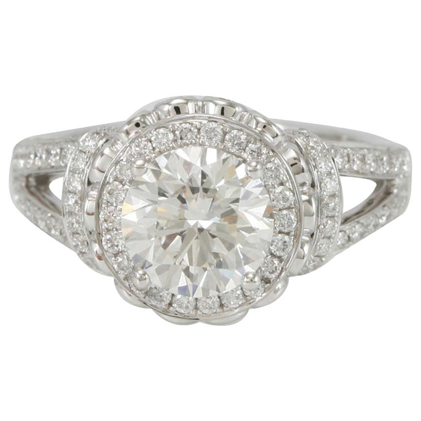 This delicious Suzy Levian ring  features a white diamond center stone (.79 ct) in an 18k white gold setting. An array of white diamonds (2.00cttw) accent the perfect style of the ring. The brilliance of these diamonds and the luster of the