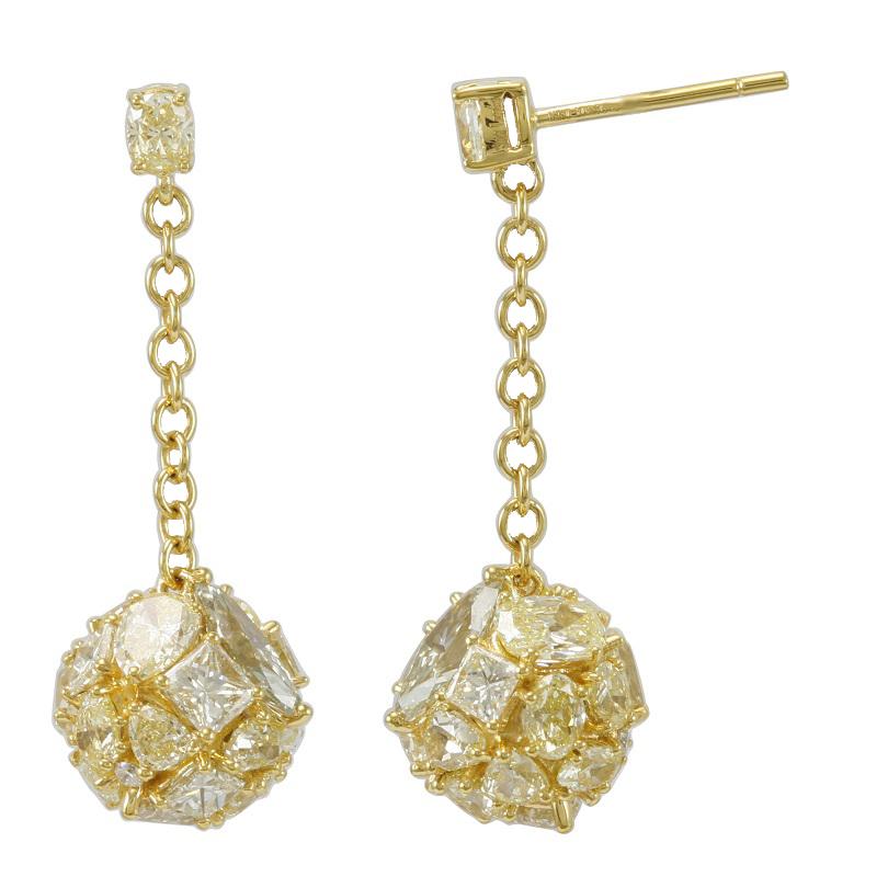 This breathtaking pair of earrings by Suzy Levian are a one-of a kind beauty, elegantly crafted in 18K yellow gold. Starting with a oval yellow diamond, these earrings hang 20mm down across a yellow gold chain, leading to a round cluster of
