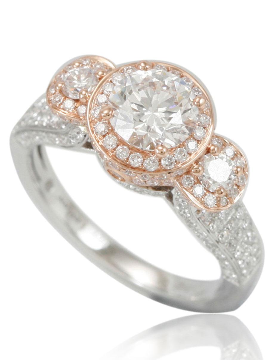 This spectacular ring from the Suzy Levian Limited Edition collection features a two-tone 18k white and rose gold setting with a round-cut, fancy  diamond center stone (1.06ct) . An array of white diamonds (1.22cttw) accents the ring perfectly as