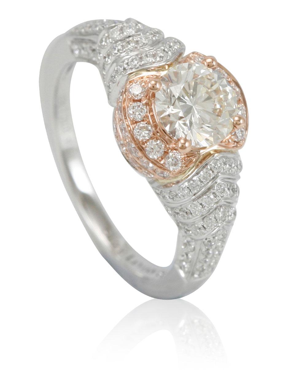 This spectacular ring from the Suzy Levian Limited Edition collection features a two-tone 14k white and rose gold setting with a round-cut, fancy yellow diamond center stone (1.01ct) . An array of white diamonds (.81cttw) accents the ring perfectly