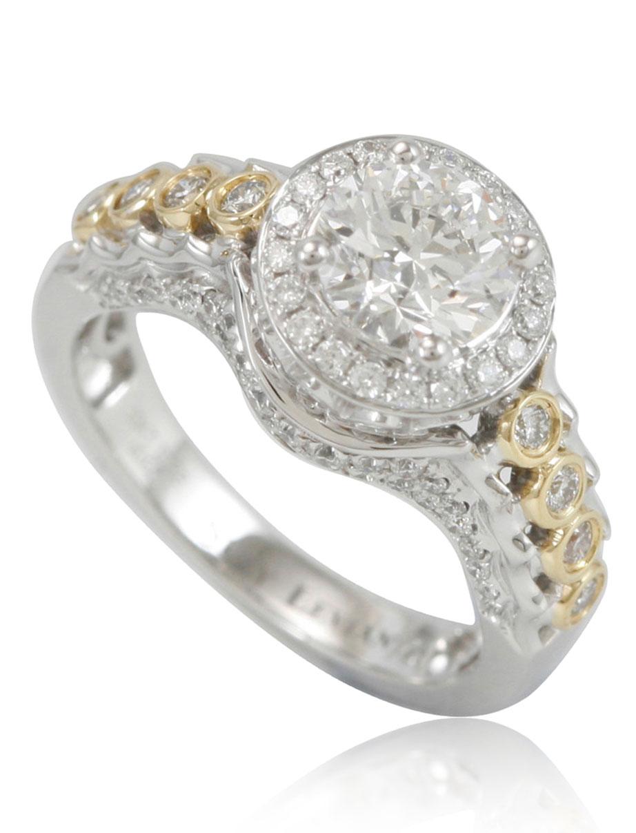 This spectacular ring from the Suzy Levian collection features a 18k two-tone white and yellow gold setting with a round-cut, fancy yellow diamond center stone (1.22ct) . An array of white diamonds (.65cttw) accents the ring perfectly as the