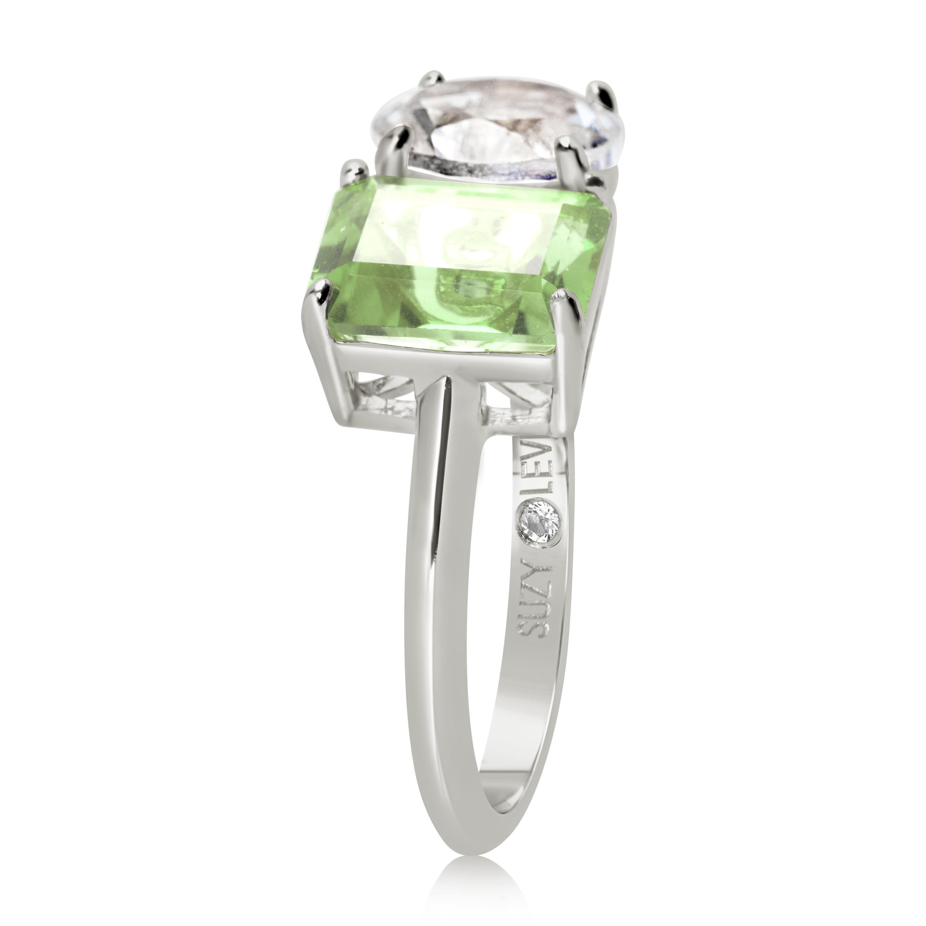 Shimmering in hues of white and green, this Suzy Levian ring is as on trend as can be, and features a round cut white topaz and an emerald cut green amethyst as a perfectly matched pair. This ring symbolizes a perfect pairing of unique shapes. This