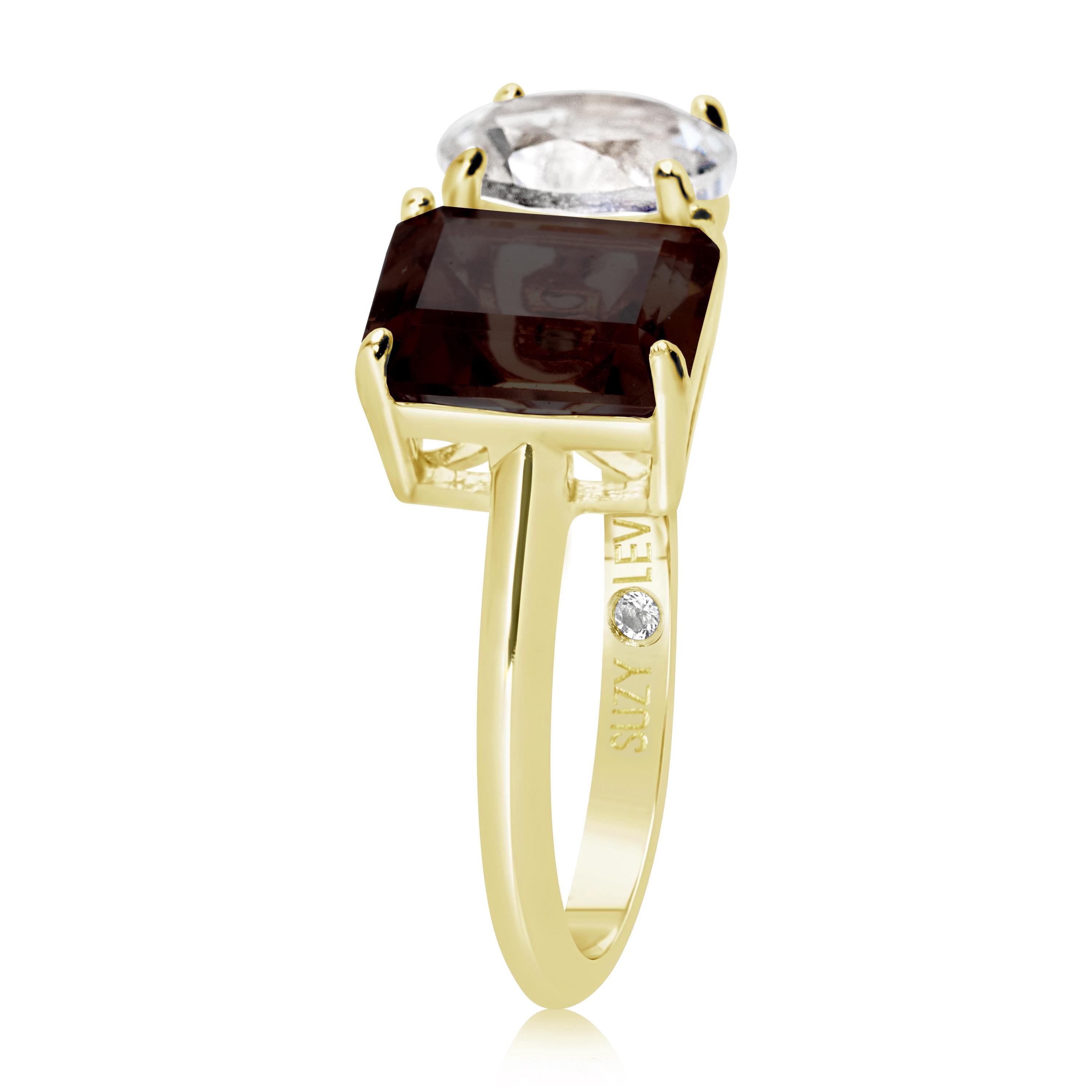Shimmering in hues of white and brown, this Suzy Levian ring is as on trend as can be, and features a round cut white topaz and an emerald cut brown smoky quartz as a perfectly matched pair. This ring symbolizes a perfect pairing of unique shapes.