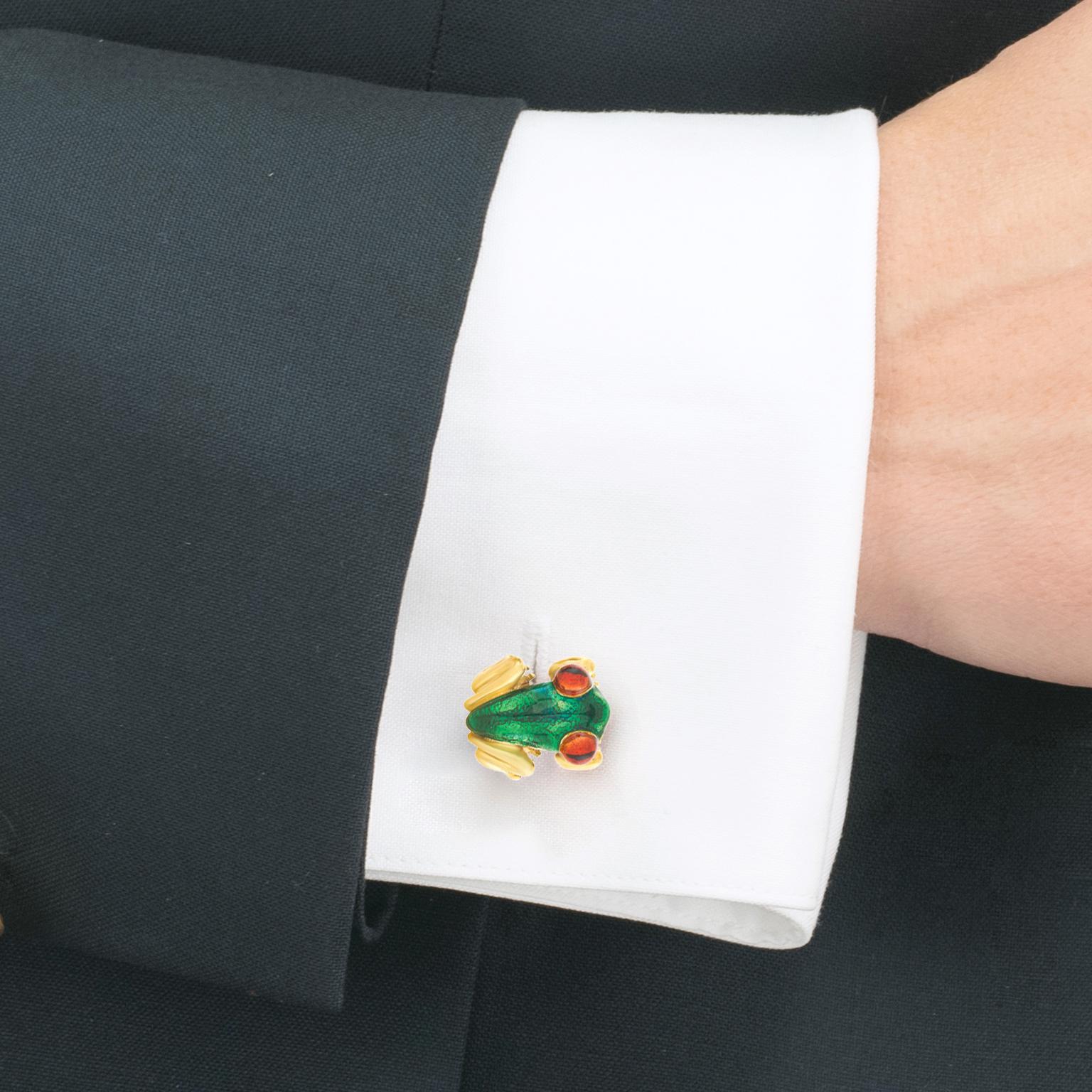 Circa 1990s, 18k, by Suzy Mor, American.  These whimsical Amazonian frogs cufflinks are beautifully detailed. Enameled in vivid green and red-amber, these well-made cufflinks are substantial in weight and in excellent condition. 

Remark: 
