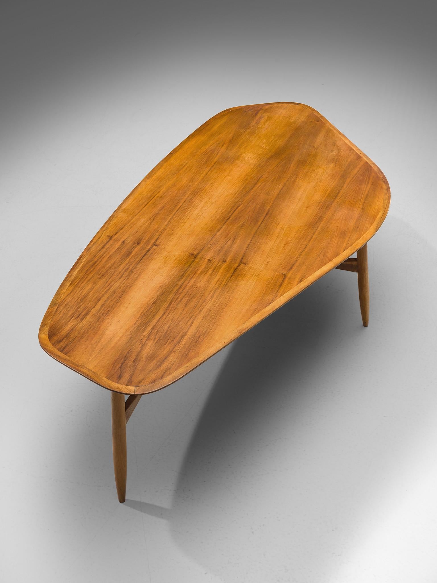 Svante Skogh, coffee table, teak, Sweden, 1950s

This freely shaped coffee table with three thin tapered legs is part is beautifully shaped and shows high attention to detail, especially by means of the connecting tripod slat between the legs.