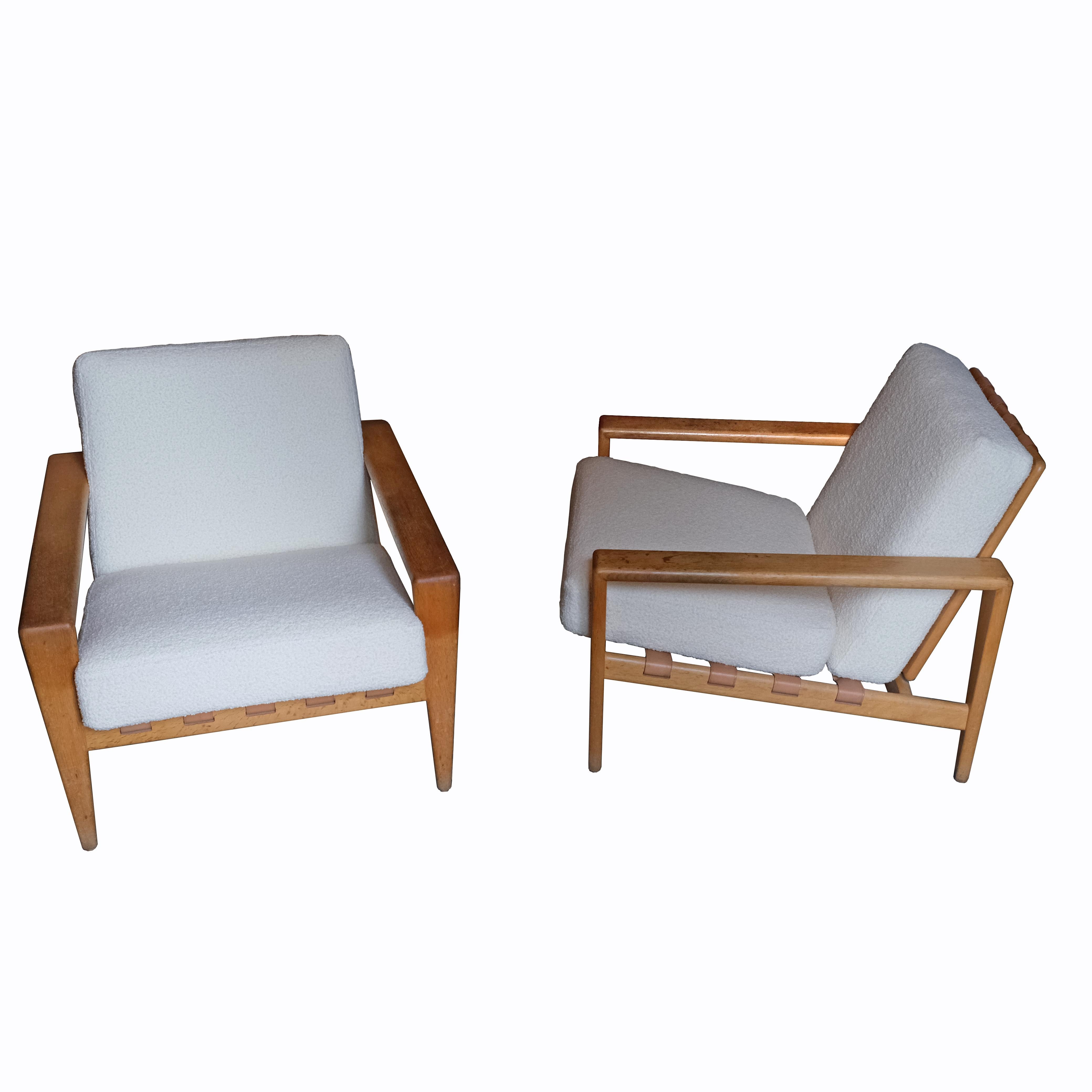 A beautiful and rare pair of lounge armchairs, with an oak frame, the seat and back with brown leather stripes.
The cushions upholstered with a Bisson-Bruunel fabric.
Produced by Seffle Möbelfabrik.
Sweden.
1950s.
 
