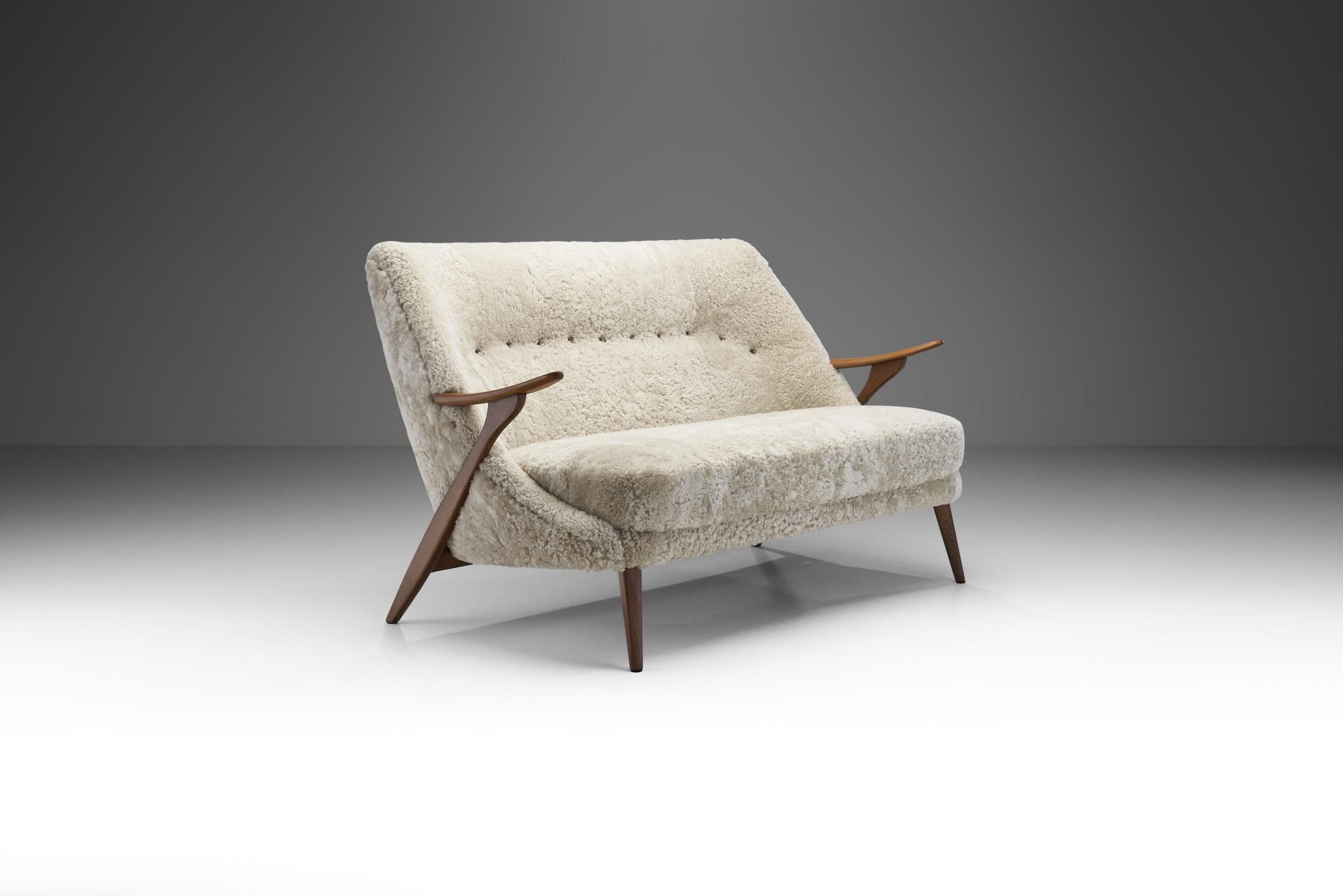 This spectacular two-seater sofa by Swedish designer, Svante Skogh, is a rather rare example of the interior and furniture designer’s repertoire. With a creative and masterfully crafted wooden structure and fully upholstered body, this model