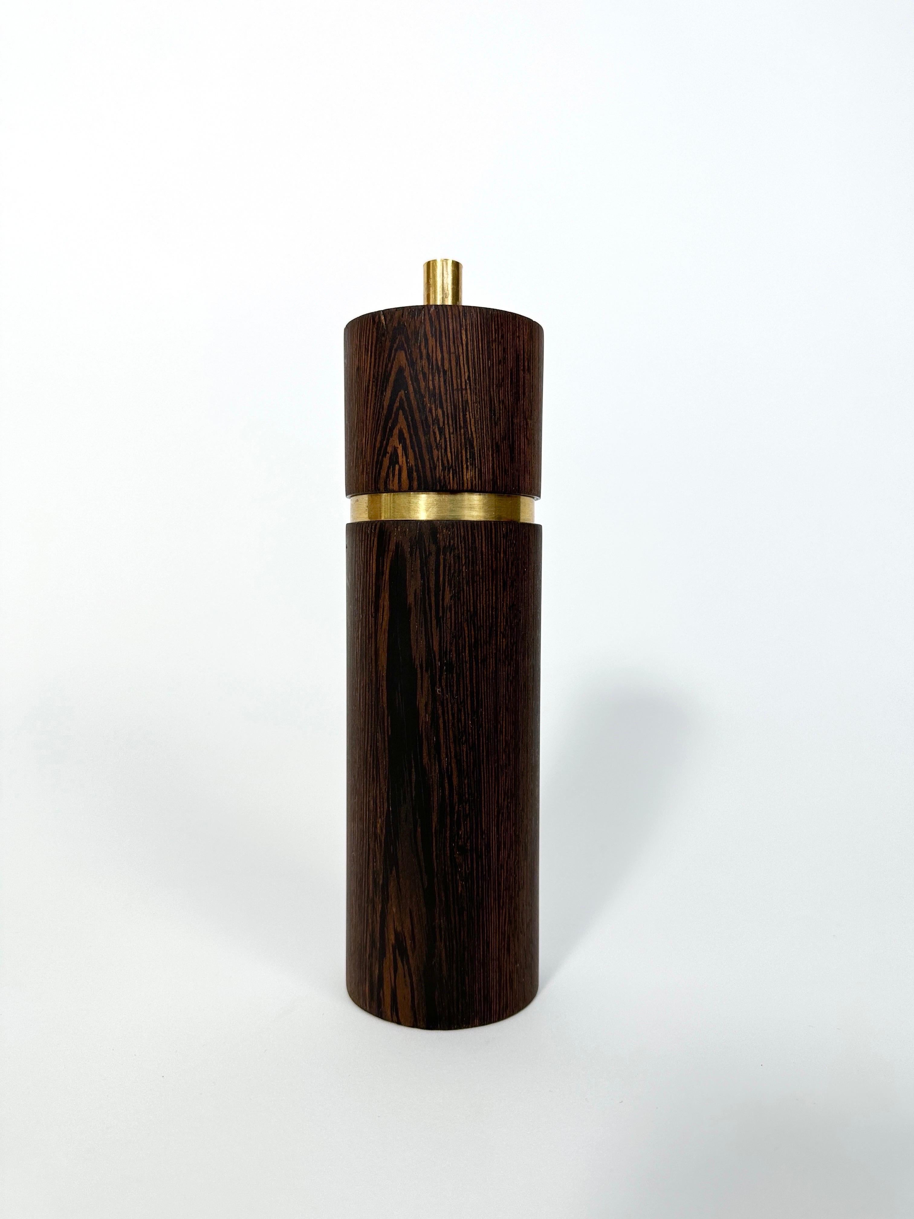 Pepper grinder designed by Sven Aage Petersen for SAAP, Denmark in the 1960s. 

Made of wengé wood & brass, quality hardware, perfectly proportioned. The mill was made by Peugeot for SAAP. 

Works great, few minor scratches here and there, patina to