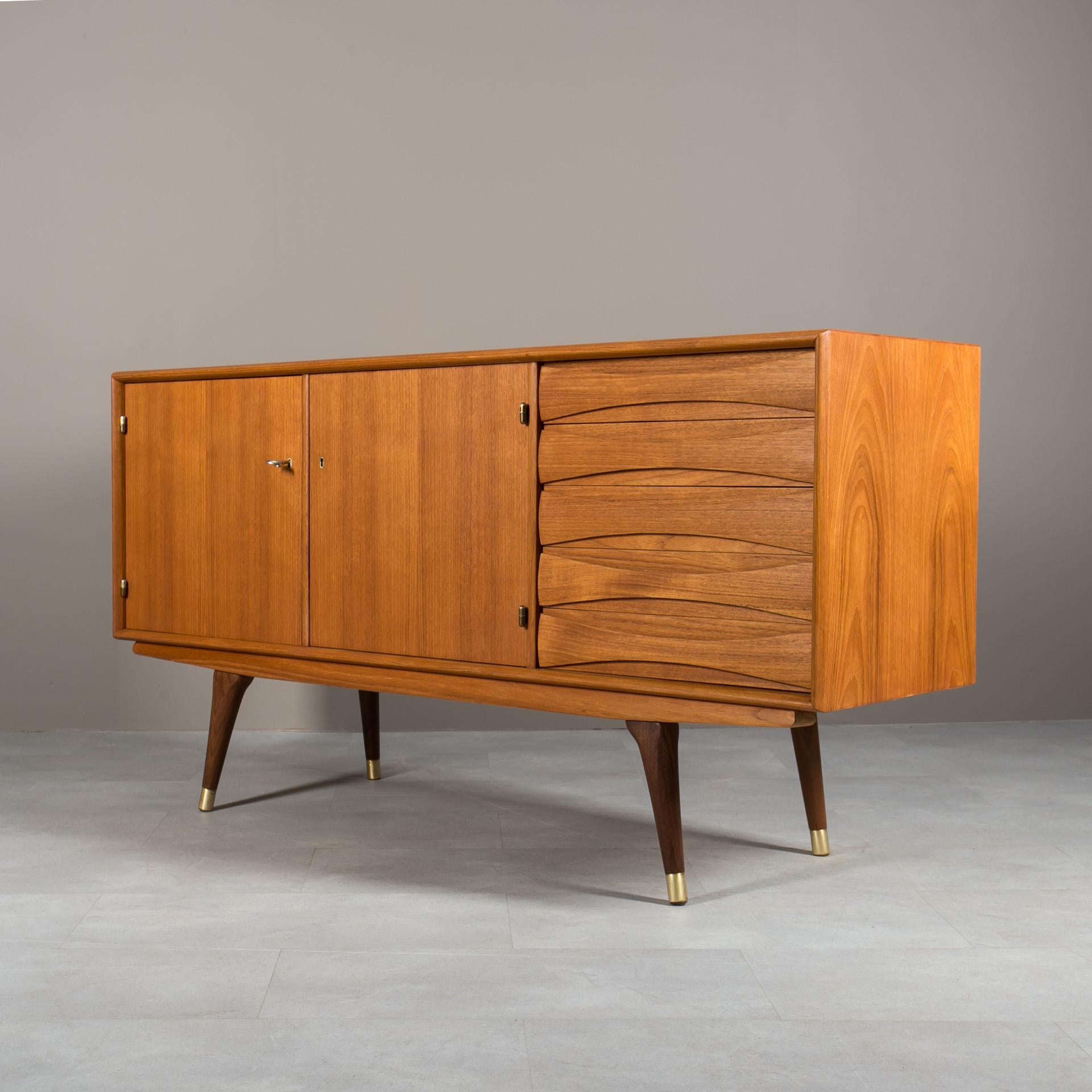 Introducing the sideboard designed by Sven Andersen – an exquisite masterpiece that seamlessly blends the timeless elegance of Scandinavian Modern design with the iconic flair of Mid-Century Modern aesthetics, taking you back to fantastic design