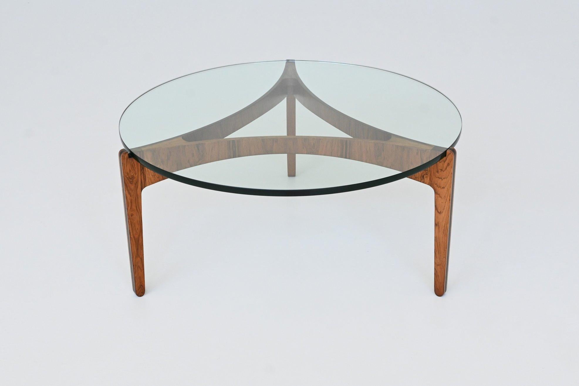 Stunning sculptural coffee table model 104 designed by Sven Ellekaer for Chirstian Linneberg, Denmark 1962. This exquisite coffee table is composed of a beautiful elegant bent rosewood base highly figured grain which supporting a thick transparent
