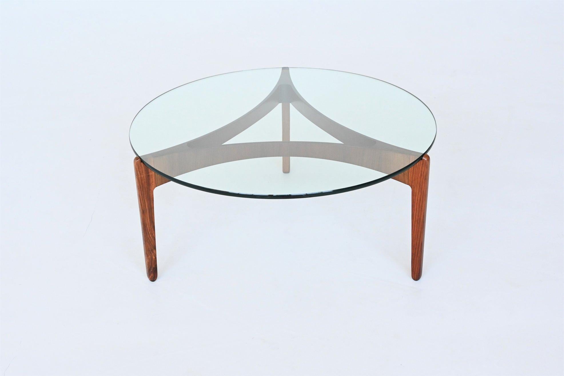 Stunning sculptural coffee table model 104 designed by Sven Ellekaer for Chirstian Linneberg, Denmark 1962. This exquisite coffee table is composed of a beautiful elegant bent rosewood base highly figured grain which supporting a thick transparent