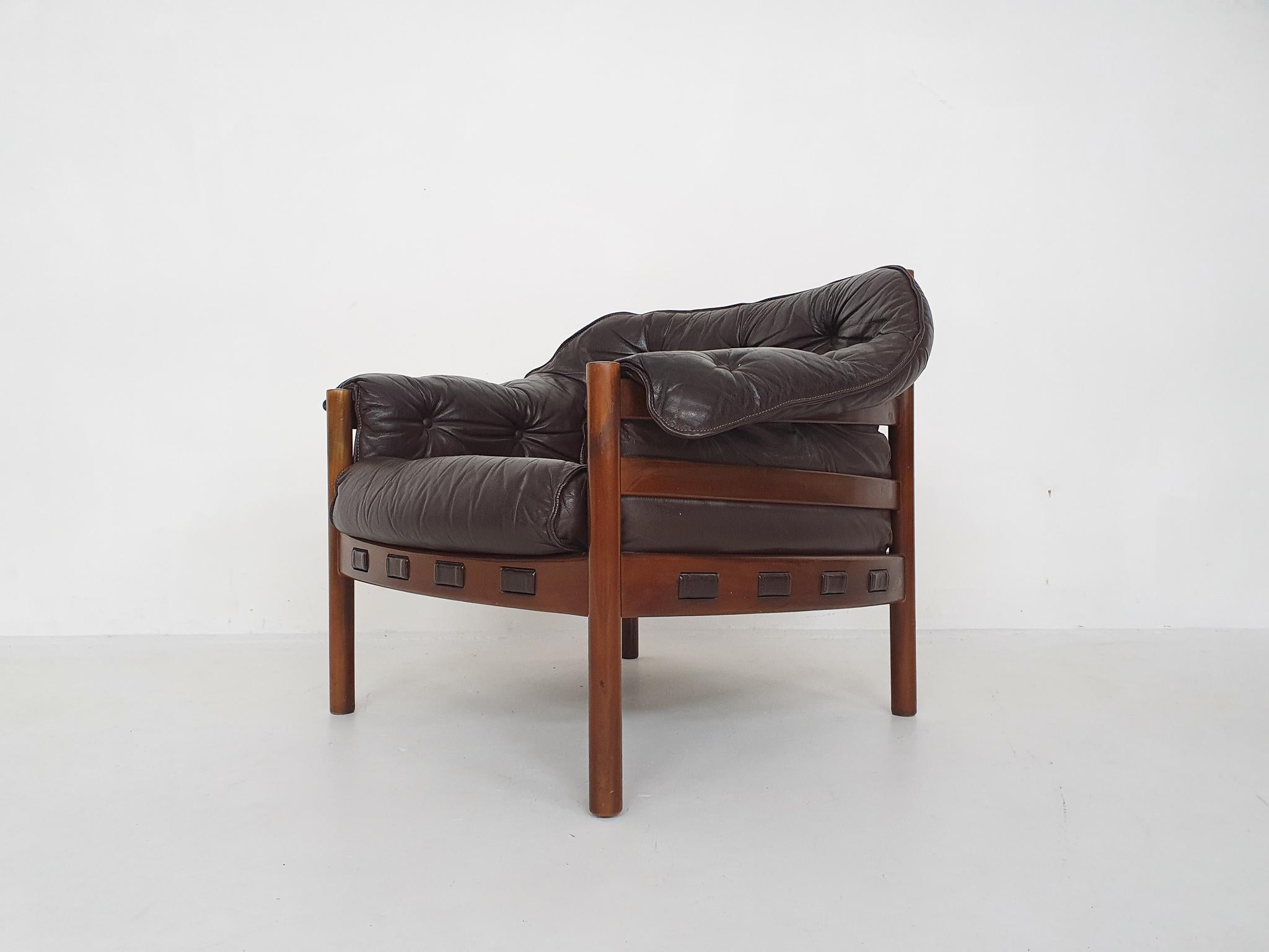 Wooden lounge chair with dark brown leather cushions. In good original condition.
 