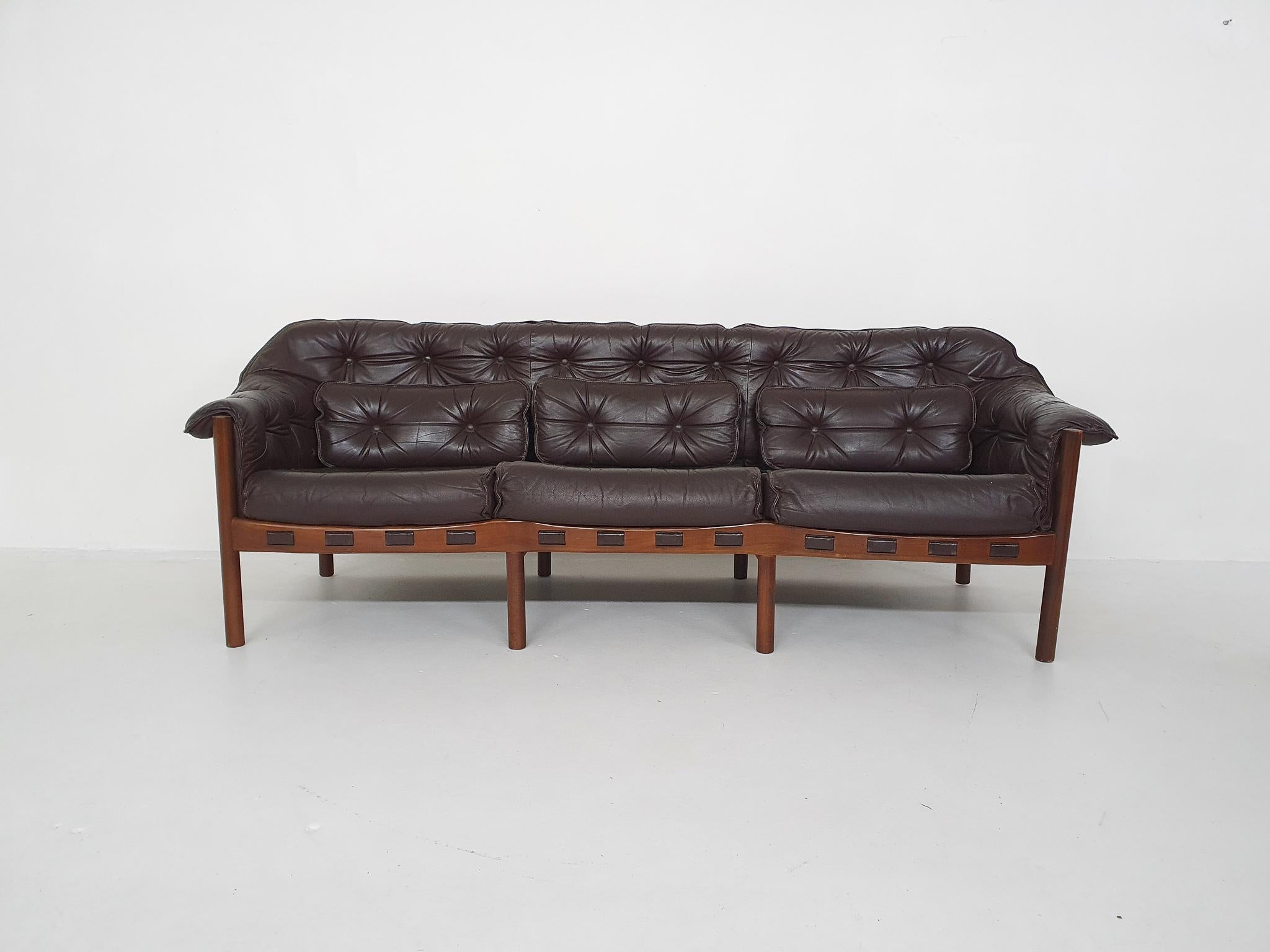 Wooden three seater sofa with dark brown leather cushions. In good original condition. With new springs.