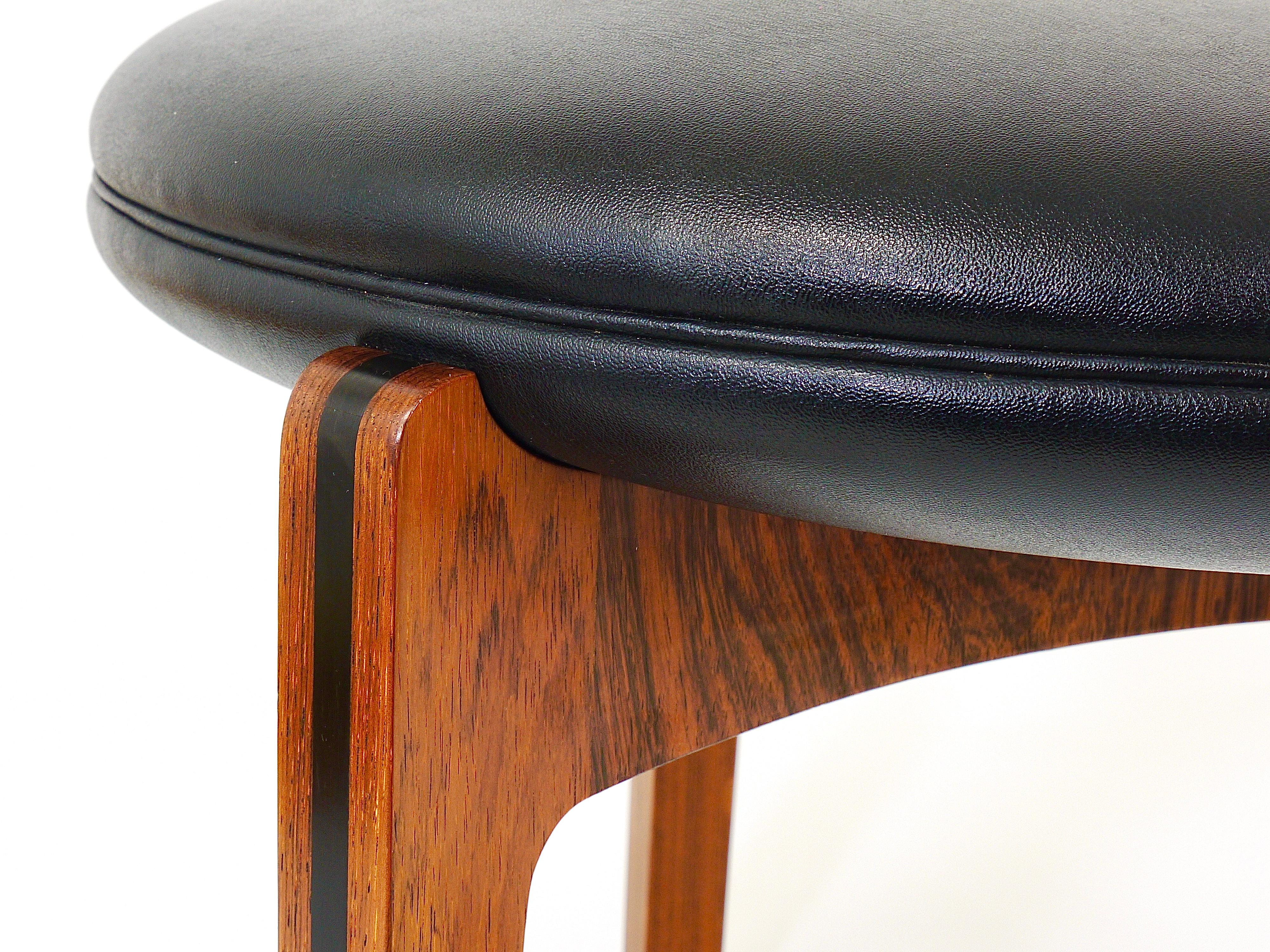 A beautiful Danish modernist stool from the 1960s, designed by Sven Ellekaer in 1962, manufactured by Christian Linneberg Møbelfabrik in Denmark. A round black skai leather cushion seating on a tripod rosewood frame. In very good condition.