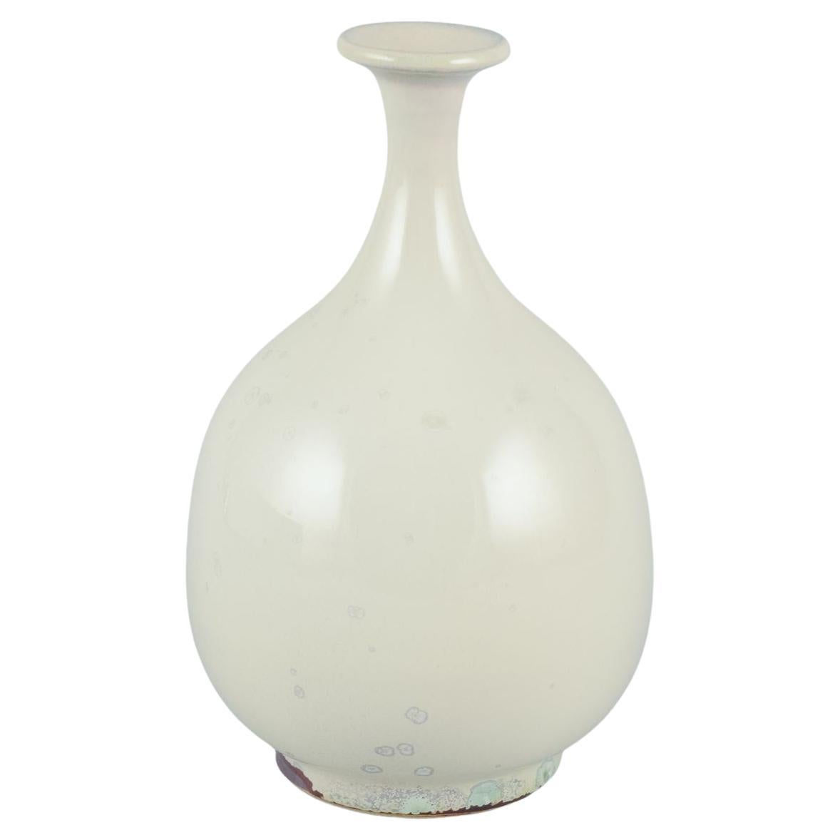 Sven Hofverberg, Swedish ceramicist, own studio. Ceramic vase with slender neck.