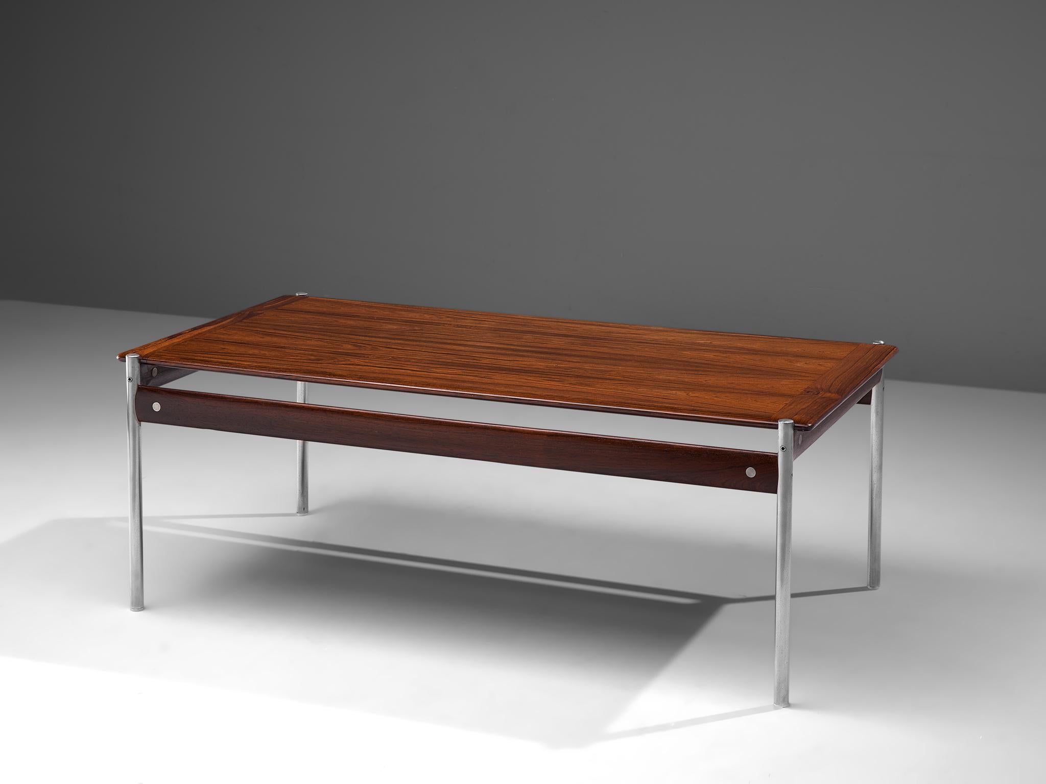 Sven Ivar Dysthe for Dokka Mobler, cocktail table model 1001, rosewood and steel, Norway, 1959.

Stately coffee table executed in high quality rosewood and with tubular steel legs. The table is designed by Sven Ivar Dysthe, being part of the 1001