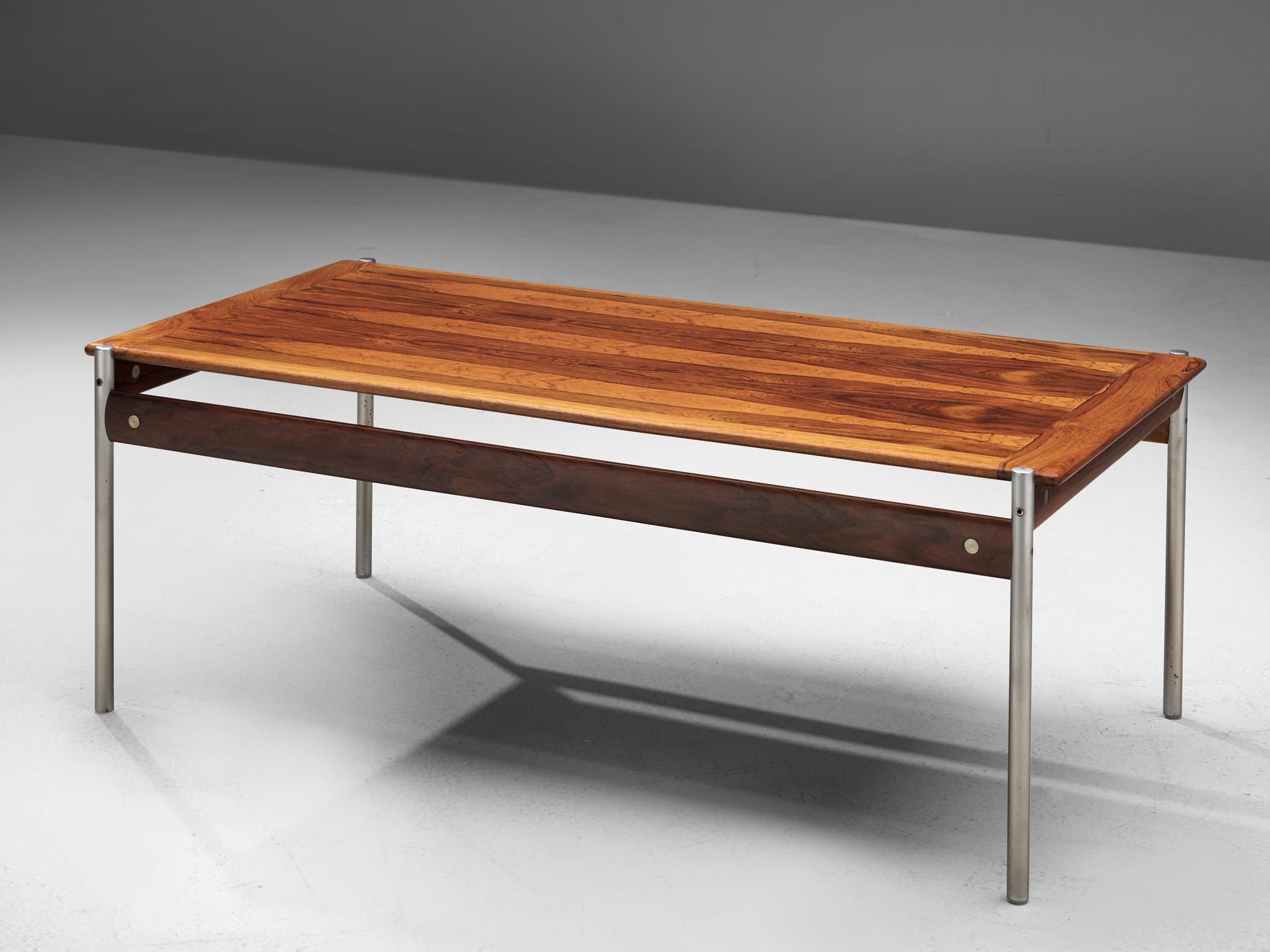 Sven Ivar Dysthe for Dokka Mobler, cocktail table model 1001, rosewood and steel, Norway, 1959.

Stately coffee table executed in high quality rosewood and with tubular steel legs. The table is designed by Sven Ivar Dysthe, being part of his 1001