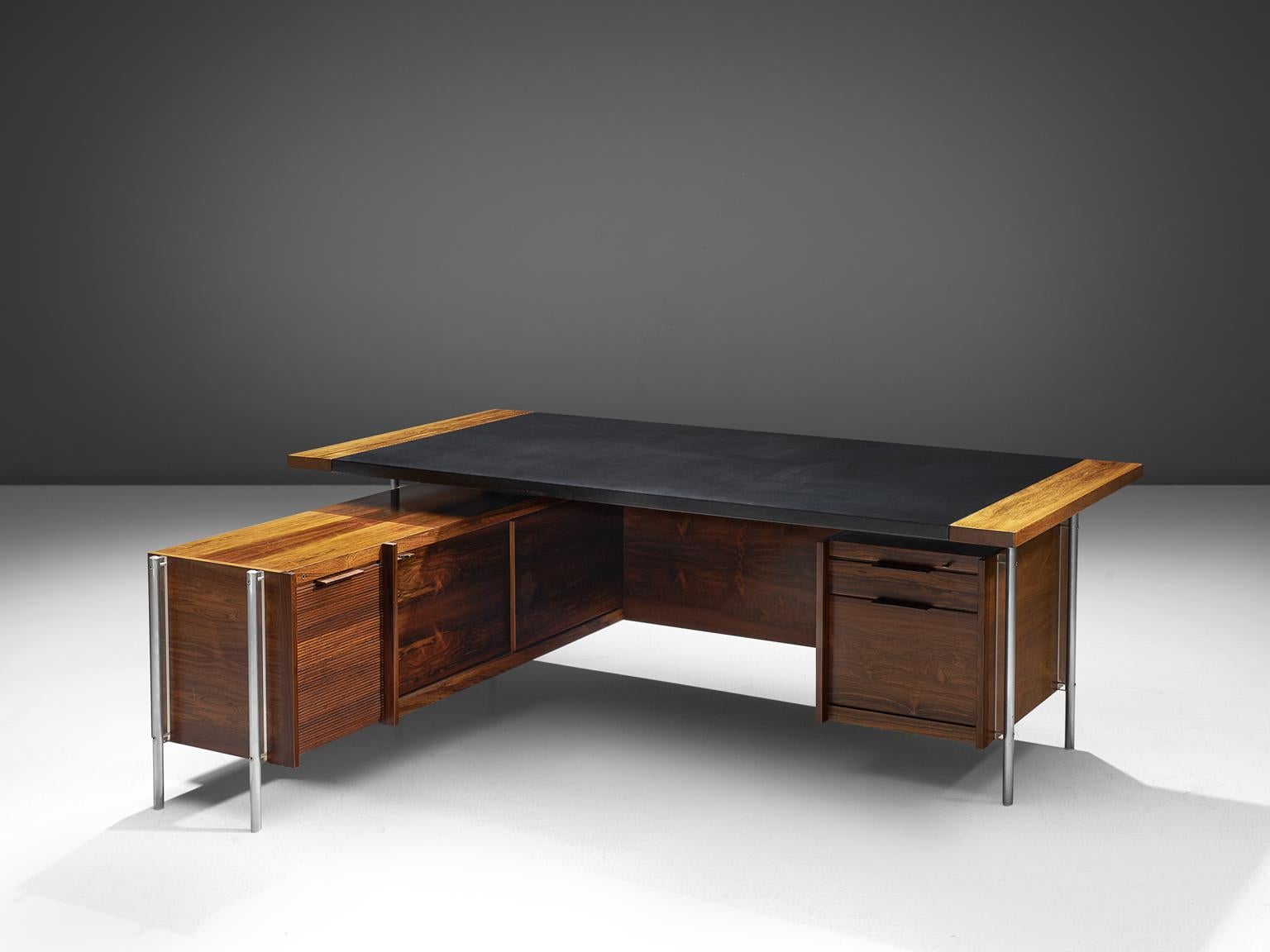 Sven Ivar Dysthe for Dokke Møbler, corner desk, black leather, steel, rosewood, Norway, circa 1959. 

The base of this desk is made out of rosewood and stainless steel pieces and black leather on the tabletop. The combination of the rosewood, the