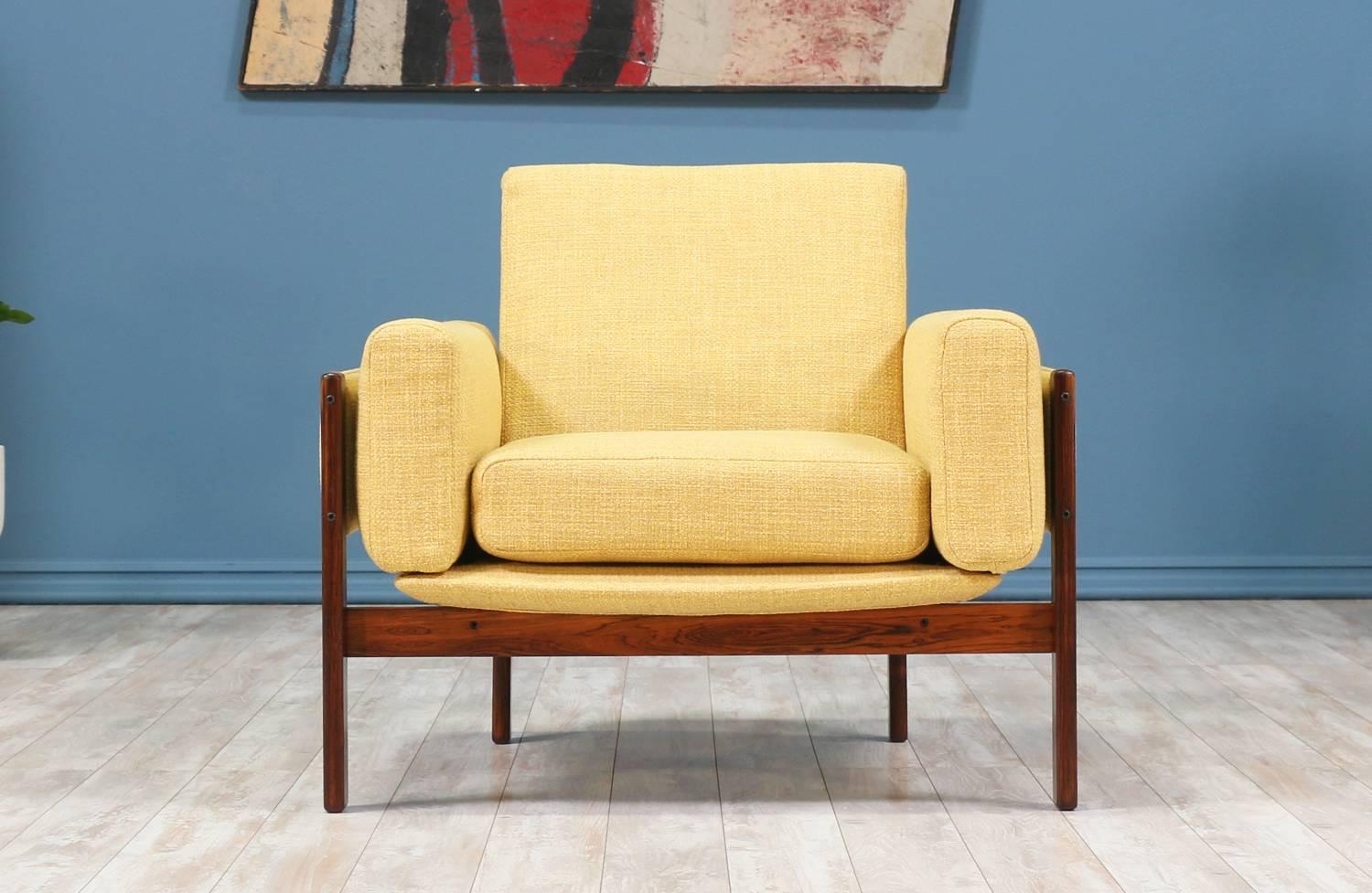 Easy chair designed by Sven Ivar Dysthe for Dokka Møbler in Norway circa 1960’s. The “Flueline” design features a Brazilian rosewood frame and a new cotton blend fabric upholstery in a beautiful creamy tone that contrasts with the dark rosewood