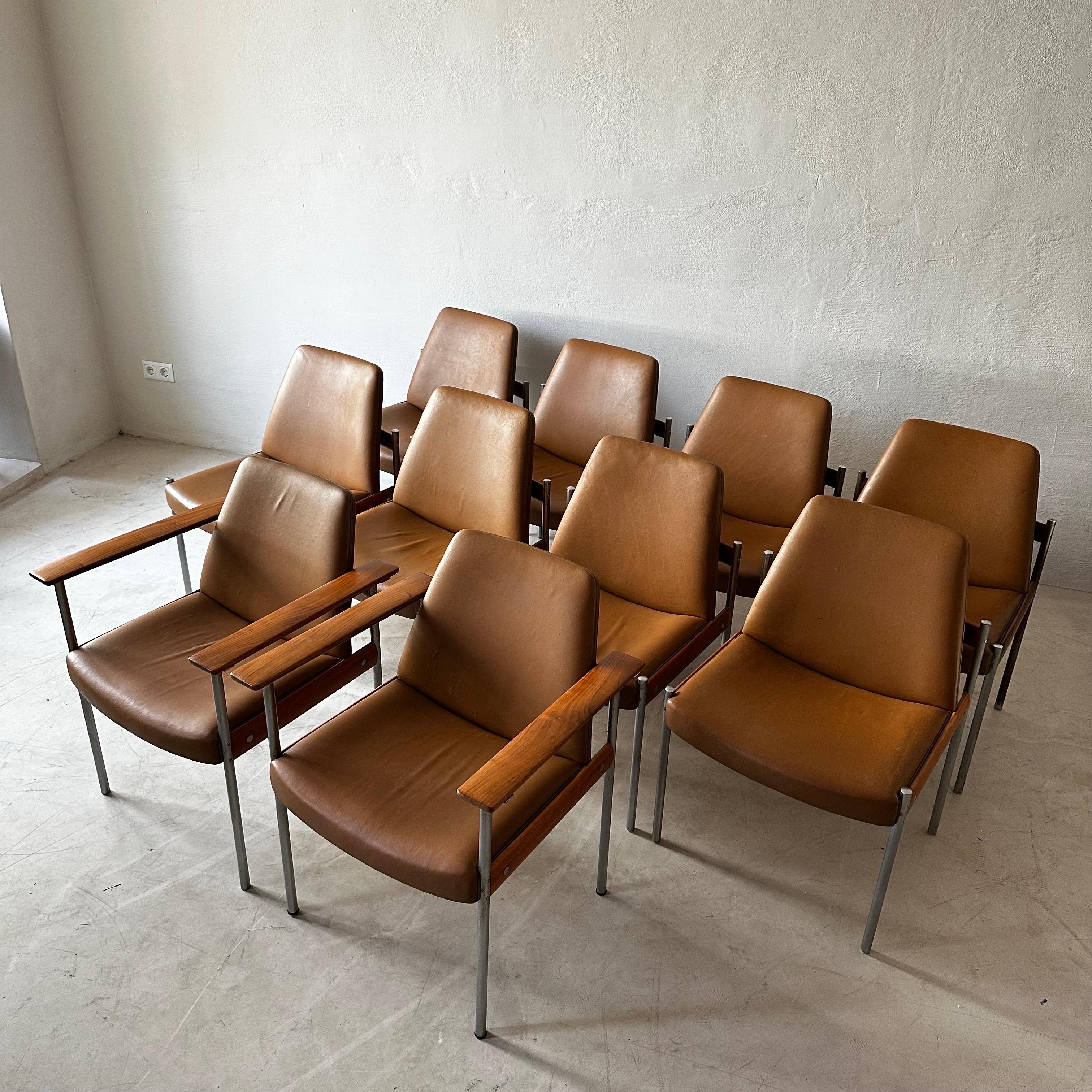 Sven Ivar Dysthe for Dokka Møbler, 10 dining chairs, cognac leather, steel, walnut, Norway, circa 1960. Two chairs come with arm rests, eight are without. A perfect combination.

The base of these office chairs is made out of dark wood and stainless