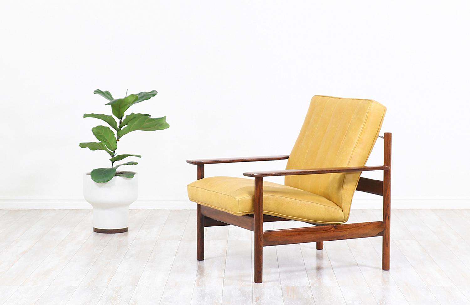 Cozy lounge chair designed by Sven Ivar Dysthe for Dokka Møbler in Norway circa 1960s. This rare and exclusive Model-1001 design features a solid Brazilian rosewood frame that supports the newly upholstered seat in mustard yellow full-grain leather.