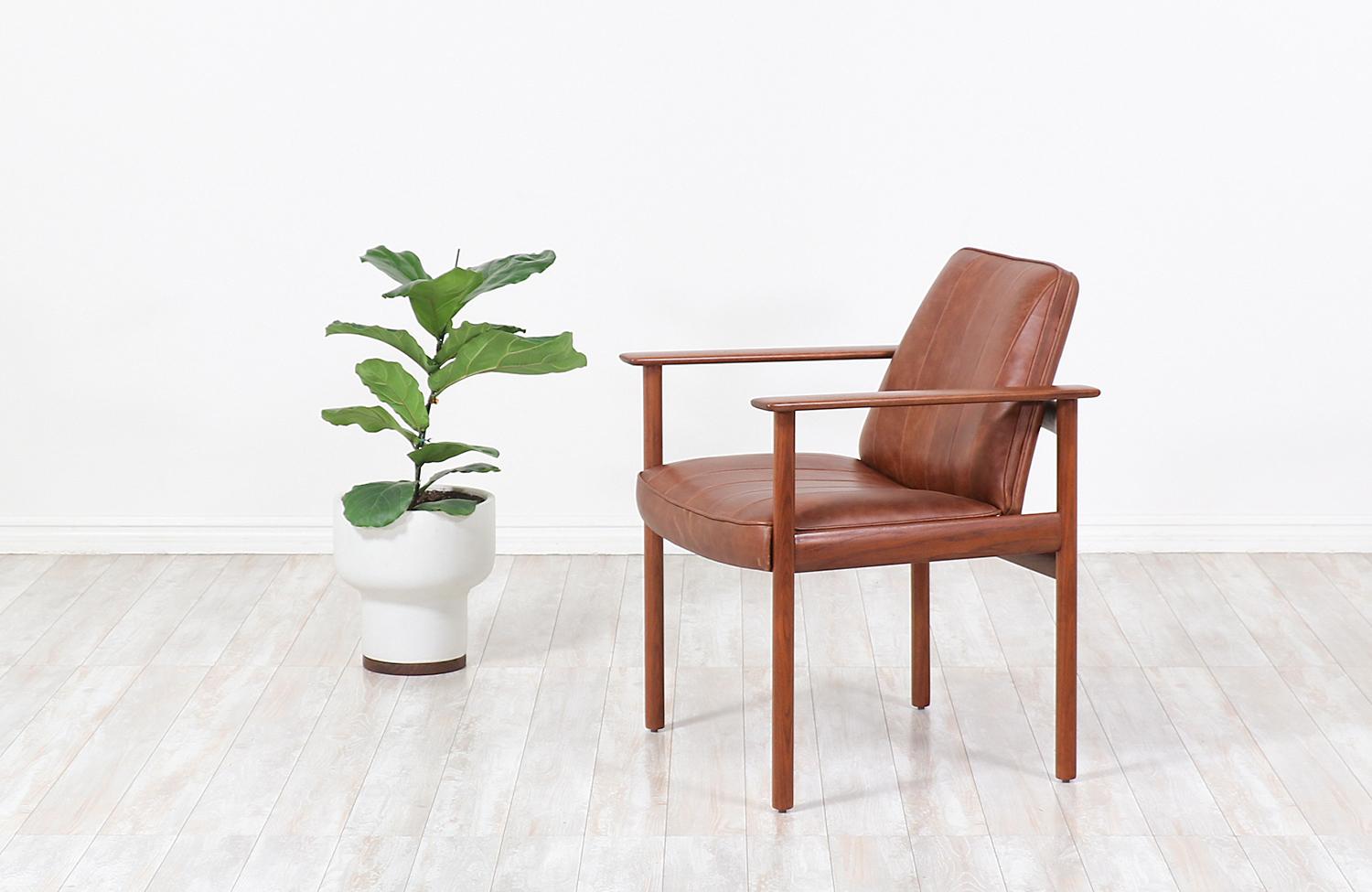 Cozy modern armchair designed by Sven Ivar Dysthe for Dokka Møbler in Norway, circa 1960s. This elegant Model-496 armchair design features a solid walnut wood frame that supports the newly upholstered seat in brown full-grain leather, making it a