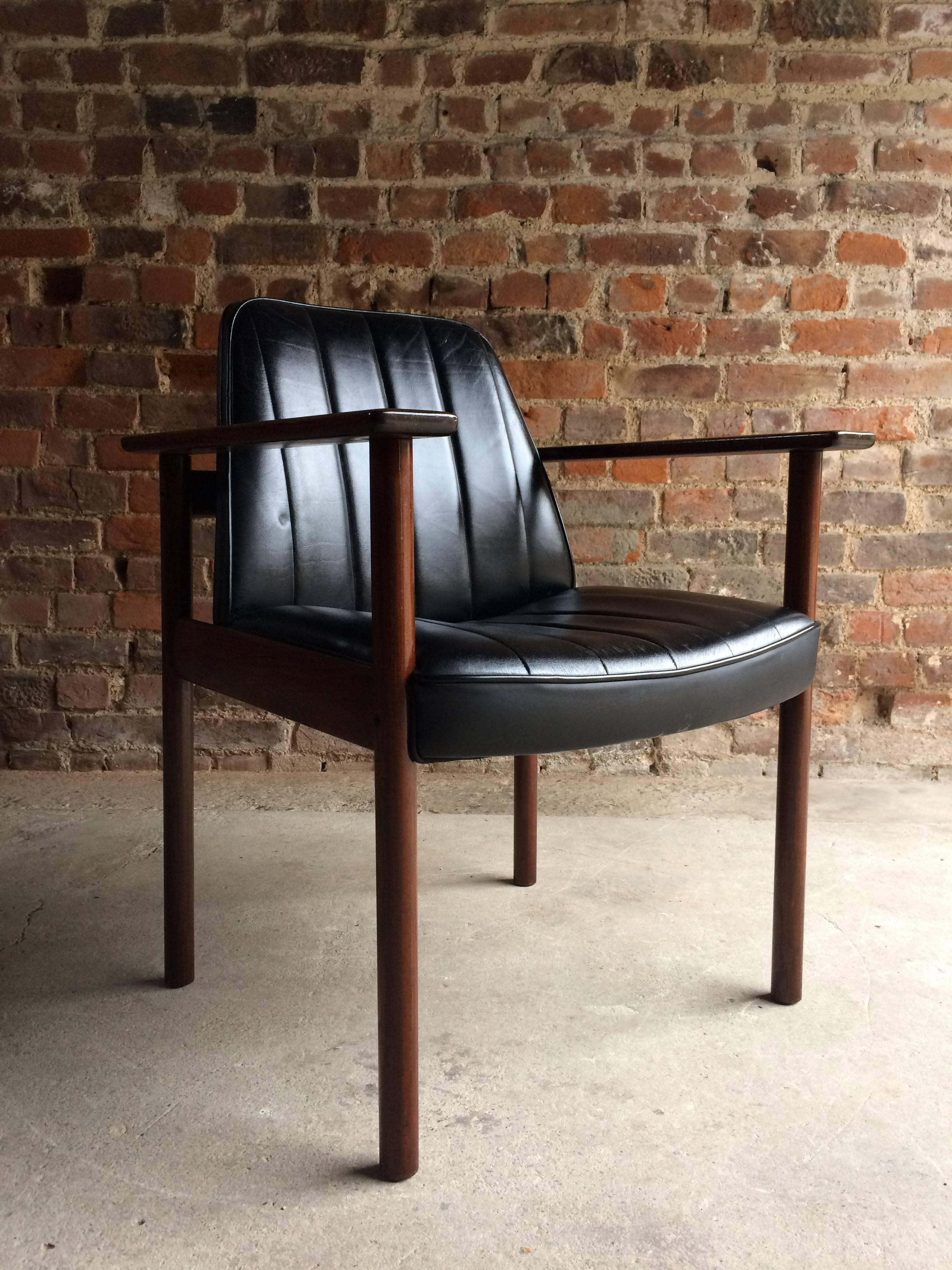 A rare chair by Norwegian design icon Sven Ivar Dysthe for Dokka Mobler solid rosewood armchair, circa 1960, the chair features a beautifully patinated black leather seat and a solid Rosewood frame, this chair is the rare version with solid rosewood