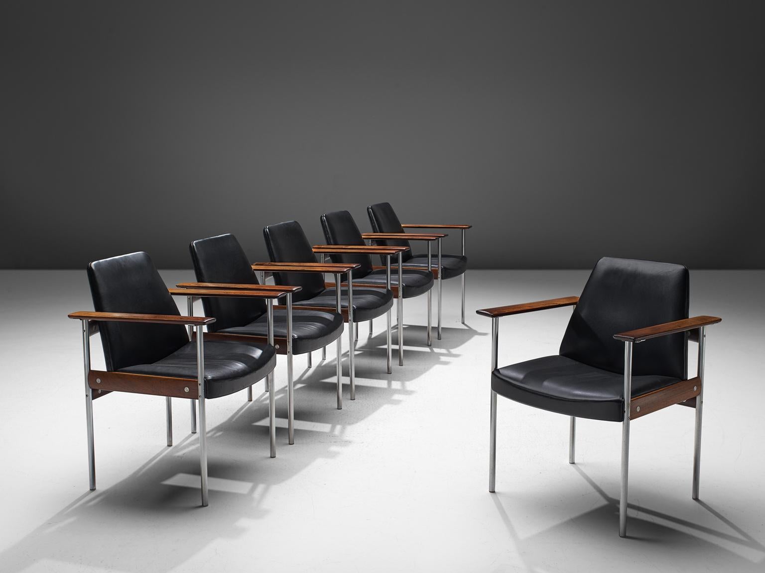 Sven Ivar Dysthe for Dokke Møbler, dining chairs, black leather, steel, rosewood, Norway, c. 1959. 

The base of these office chairs is made out of rosewood and stainless steel pieces and black leather on the chairs themselves. The seats are