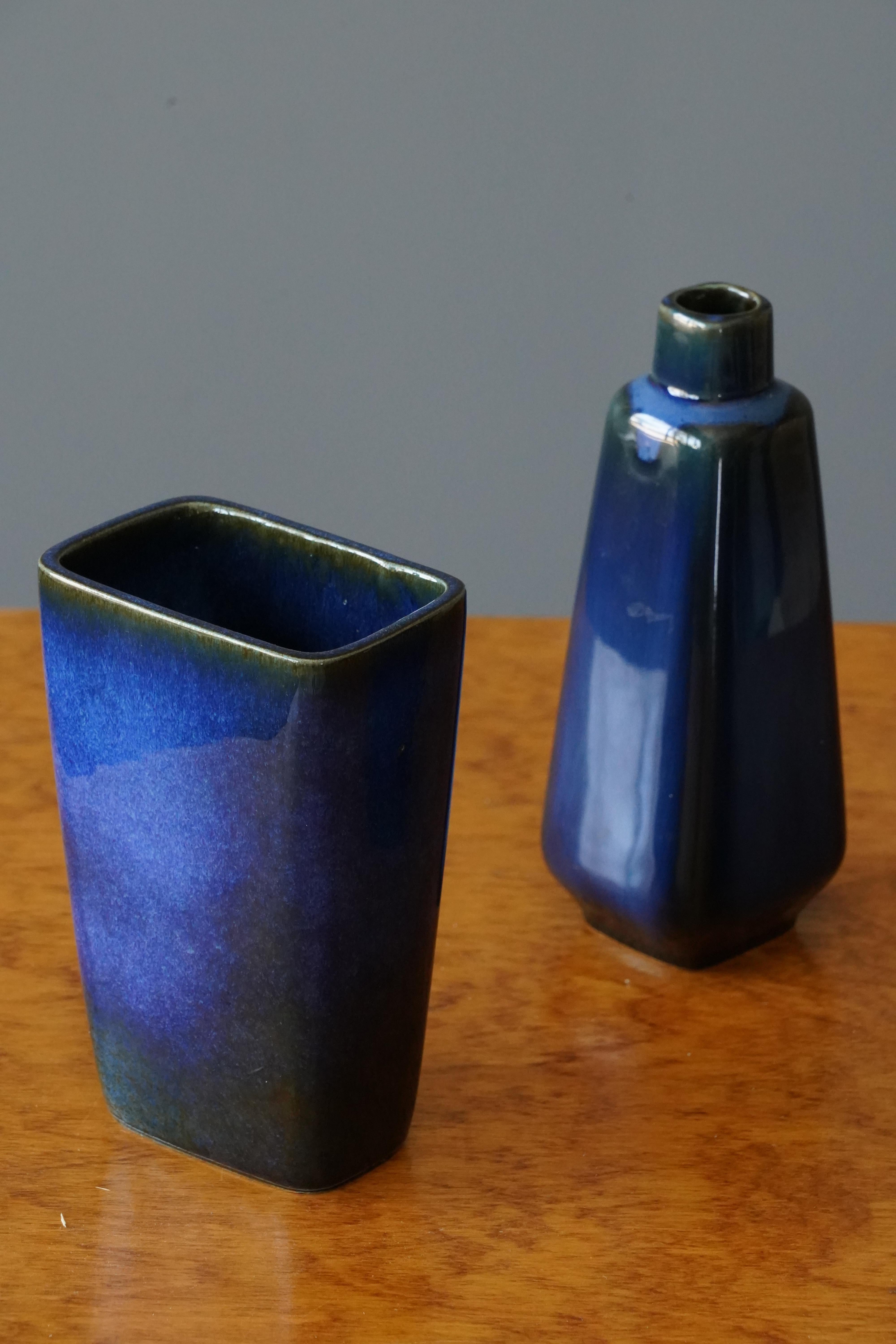 A set of three vases designed by Sven Jonsson for Gustavsberg. Designed and produced in the 1960s. In blue glazed stoneware. 

Dimensions for three vases - 2.8 x 4.25 x 6.75 / 3x 3x 8.2 / 2.2 x 3 x 5.