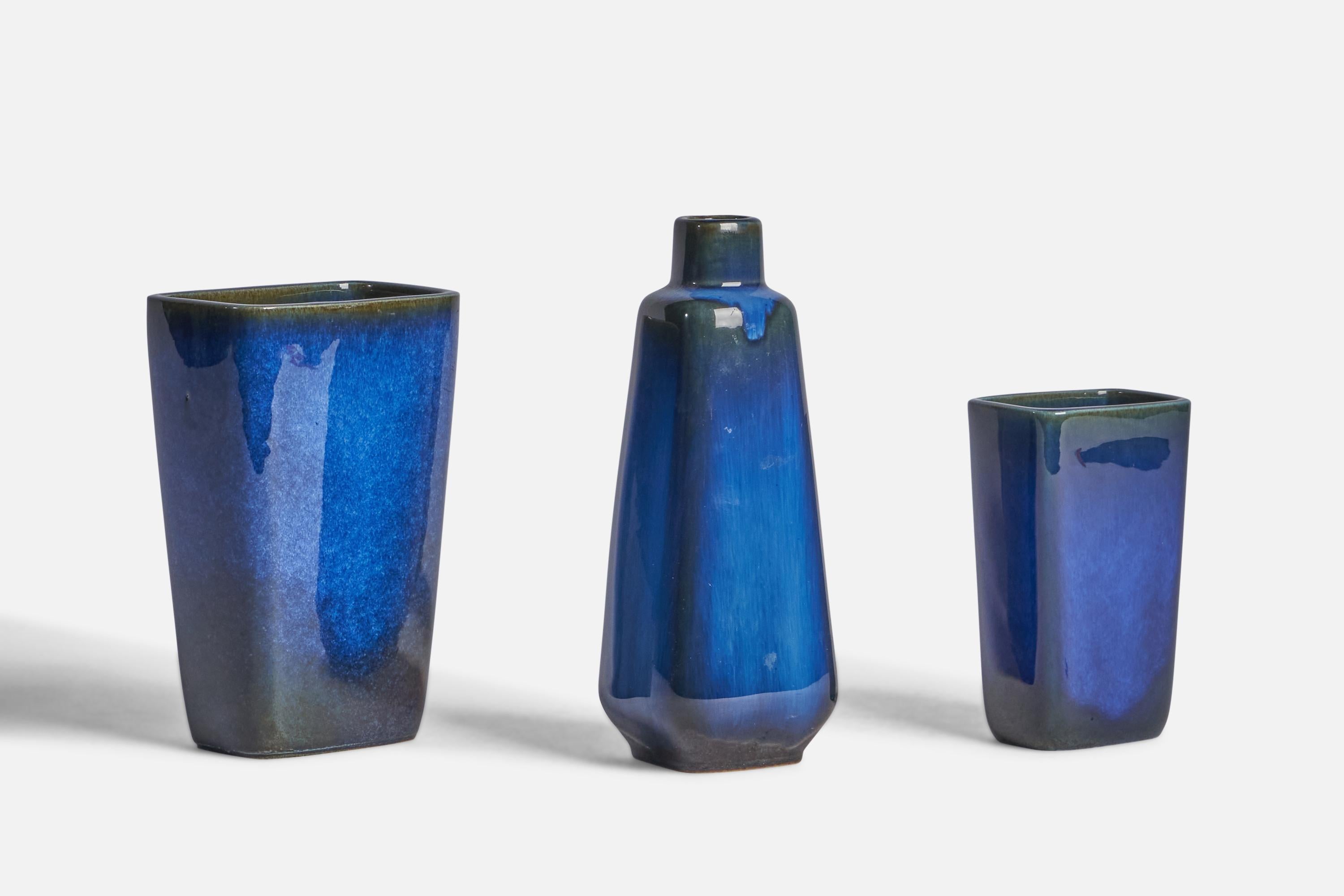 A set of 3 blue-glazed stoneware vases designed by Sven Jansson and produced by Gustavsberg, Sweden, c. 1960s.

Overall Dimensions (inches): 8.25” H x 3” W x 3” D
Overall Dimensions (inches): 6.75” H x 4.4” W x 2.9” D 
Overall Dimensions (inches):