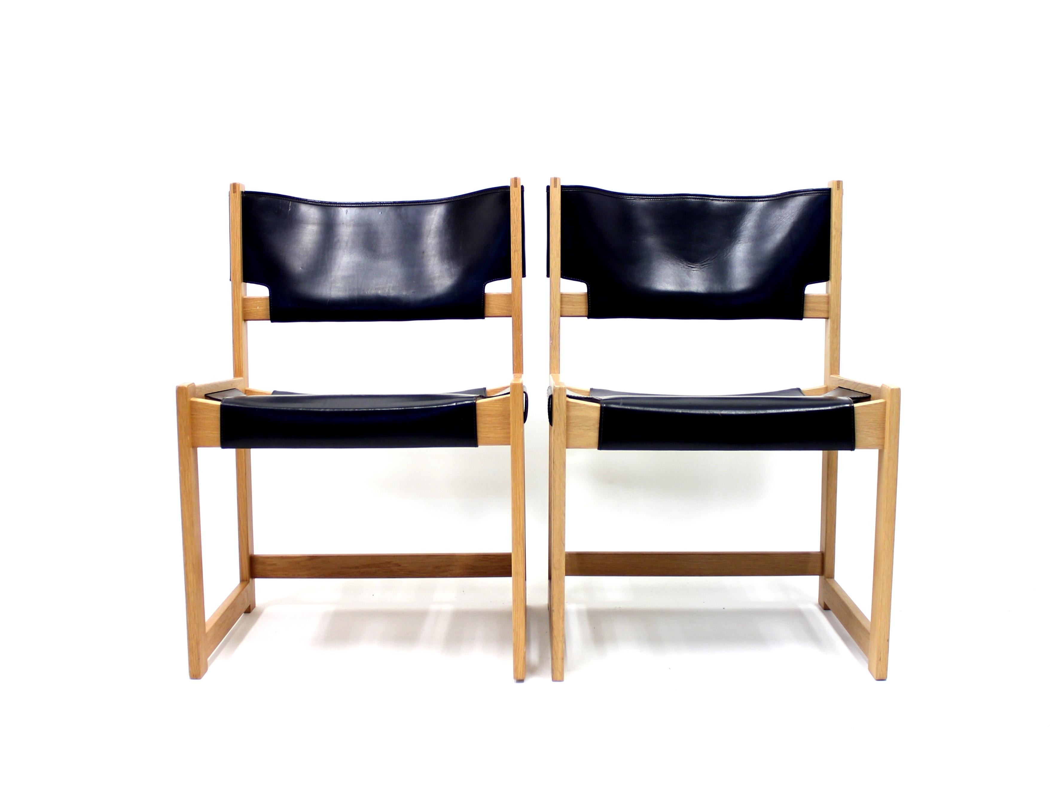Armchair designed by Sven Kai Larsen for Swedish manufacturer Nordiska Kompaniet in the 1960s. It´s made of solid pine and black leather. Good vintage condition with some patina on the leather.