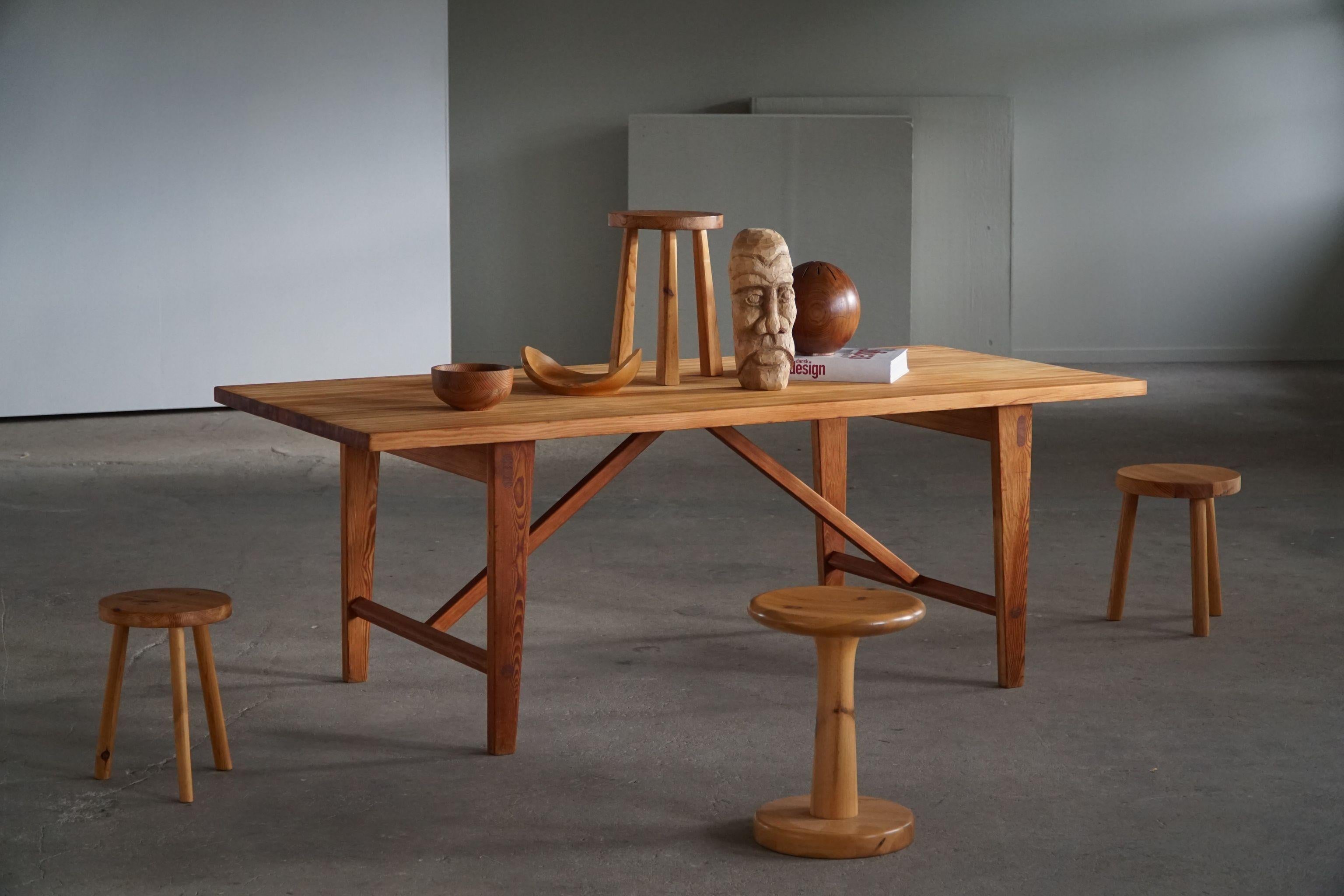 A rectangular dining table in solid pitch pine with beautiful structure and wood grains. Highlighted details, such as the nice craftsmanship seen in the large wooden dowels. Attributed to Architect Sven Larsson, Sweden, made in 1960s. This table has