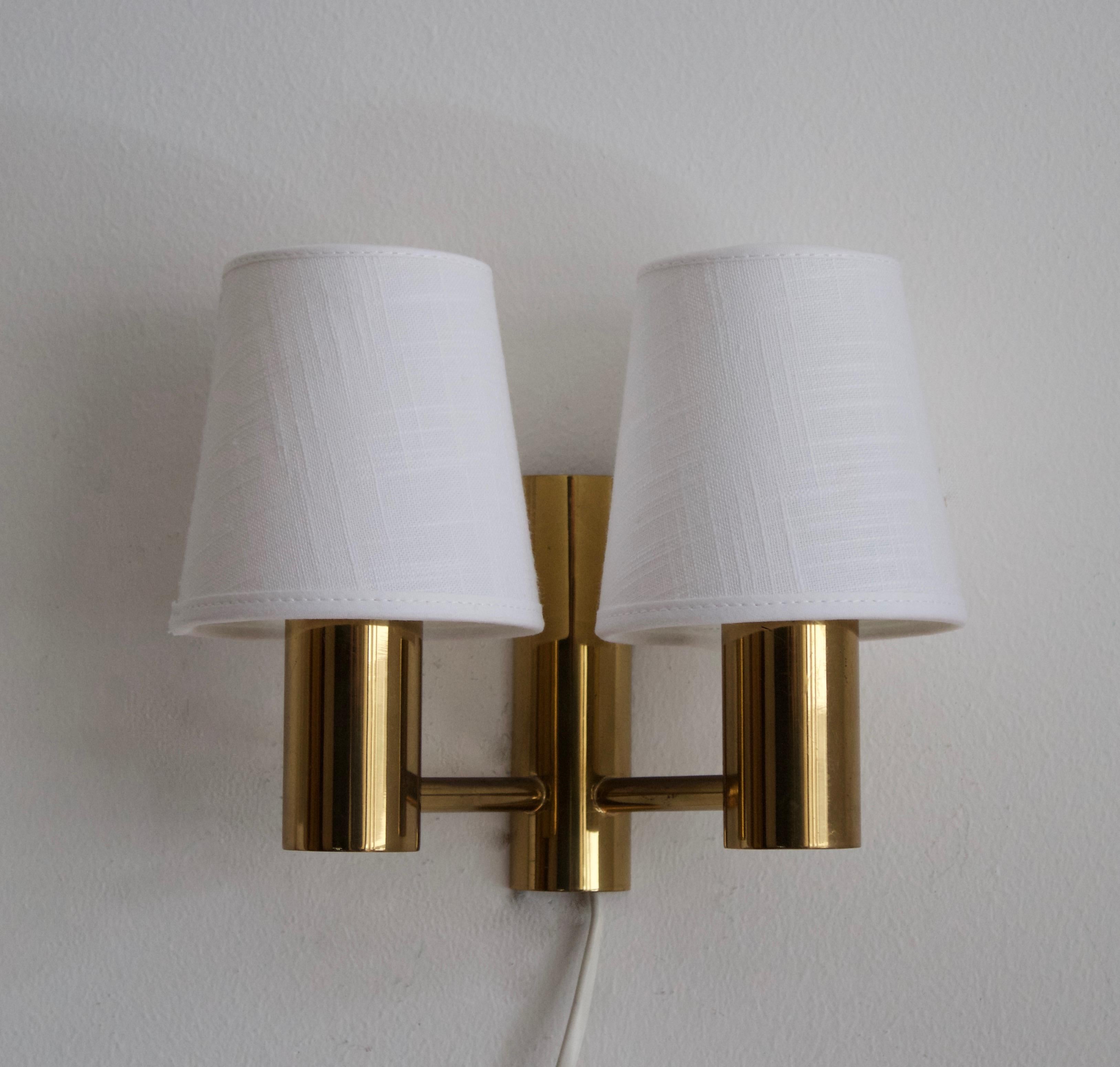 A wall light or sconce. Design attributed to Sven Mejlstrøm, for MS Belysning, Denmark, 1960s. In brass, with brand new lampshades. Labeled 