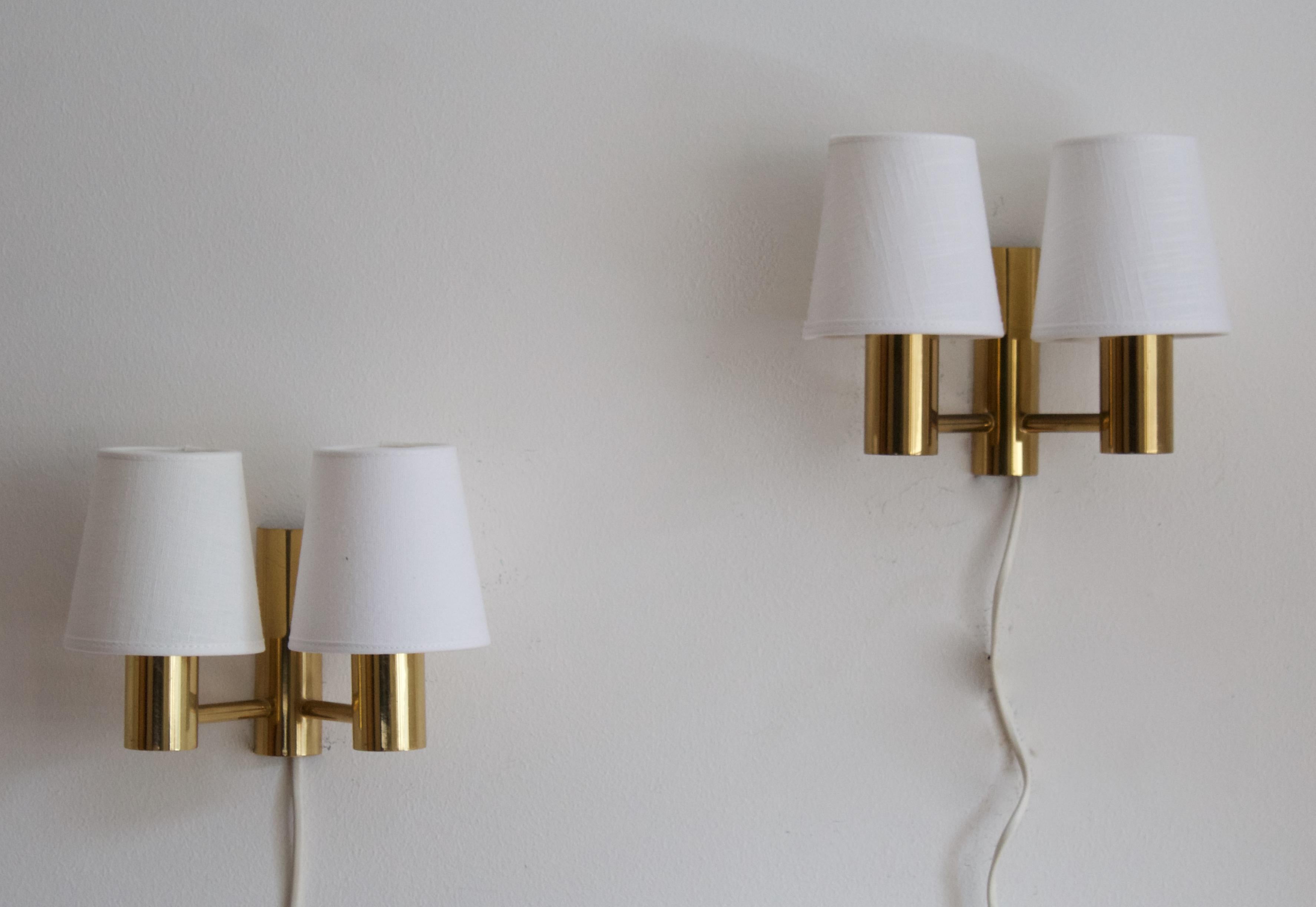 A pair of wall lights or sconces. Design attributed to Sven Mejlstrøm, for MS Belysning, Denmark, 1960s. In brass, with brand new lampshades. Labeled 