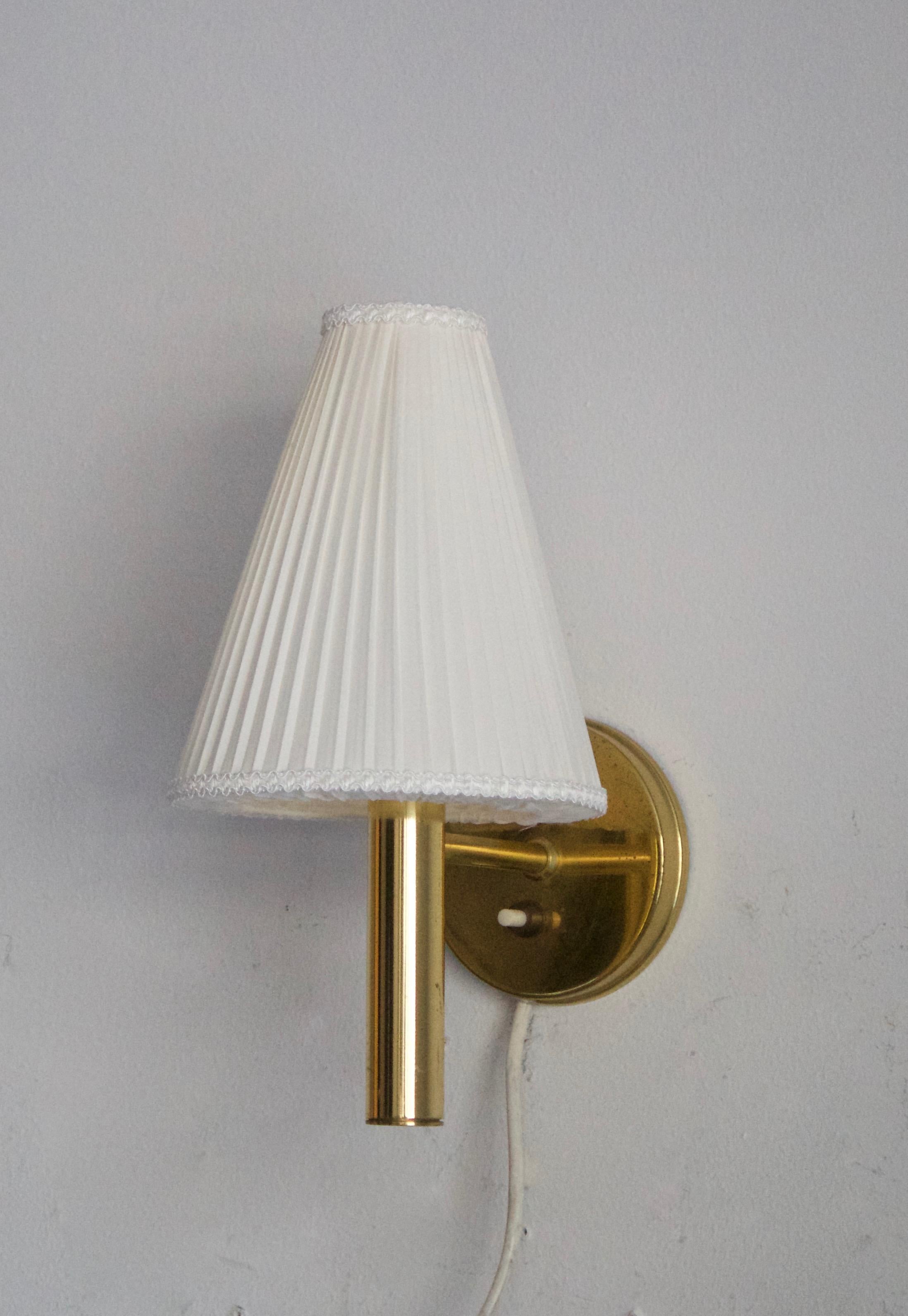 A pair of wall lights or sconces designed by S.O.A. Mejlstrøm, for MS Belysning, Denmark, 1960s. In brass, with brand new lampshades. Labeled.