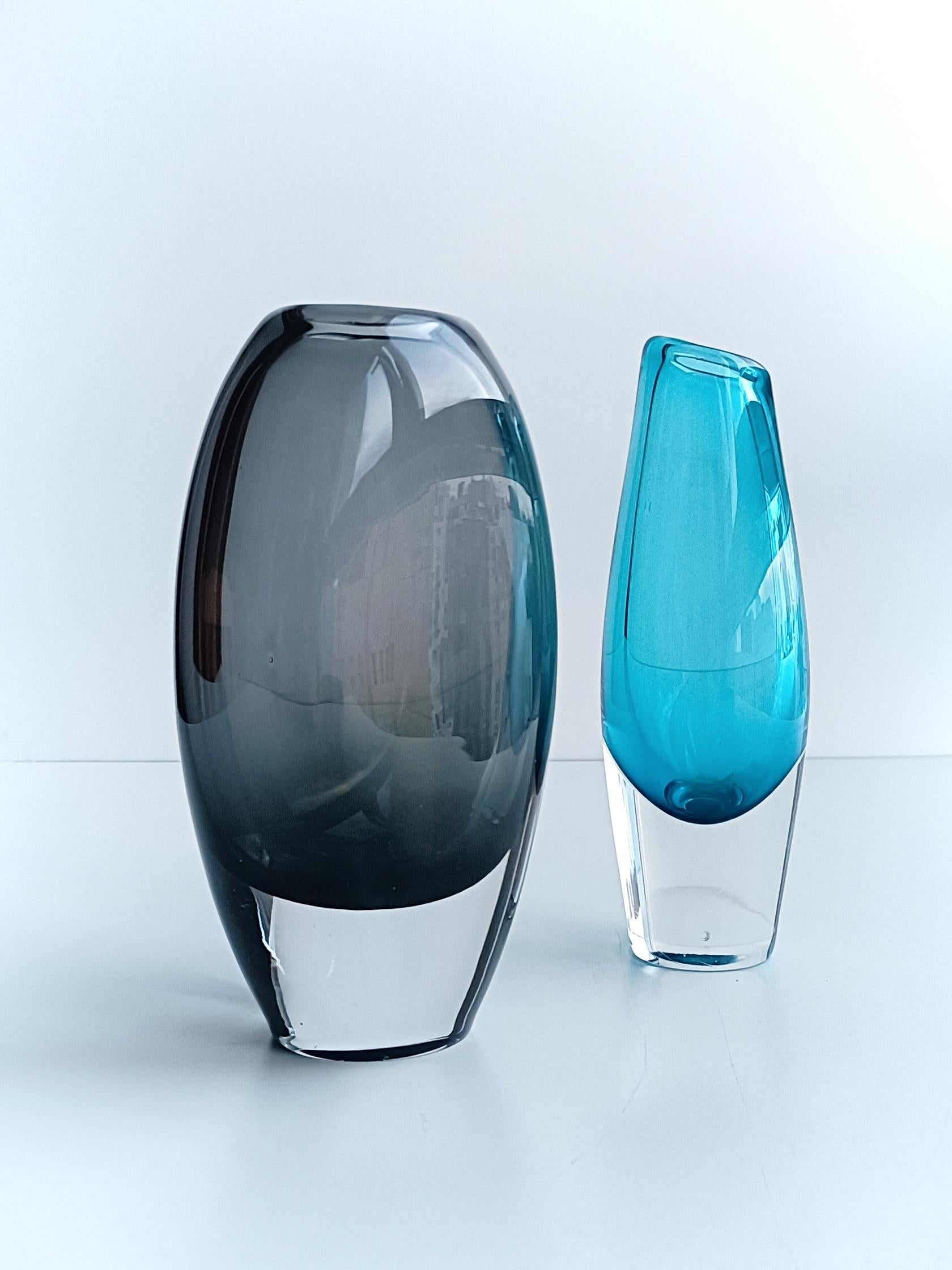 Mid-Century Modern minimalist Scandinavian glass pair of vases by Sven Palmqvist for Orrefors  - hand produced in Sweden, circa the 1950s. 

They are stunning in the hand. Absolutely gorgeous to decorate the top of a sideboard, a chest of drawers or
