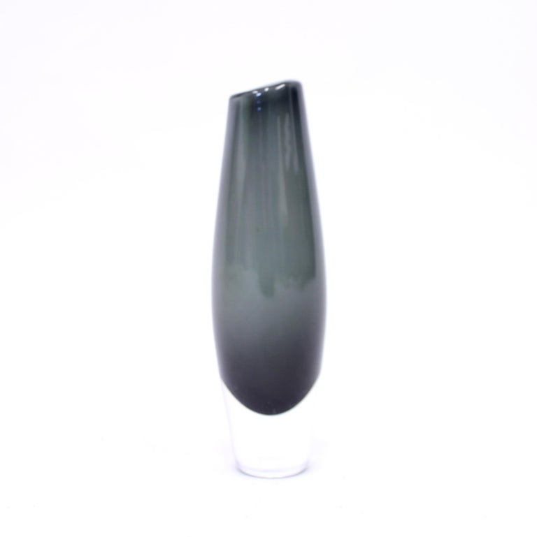 Smoke grey glass vase designed by Sven Palmqvist for Orrefors in 1950s. Surface with some light scratches and ware. Only visible in certain lights. Otherwise in good vintage condition with normal ware consistent with age and use.