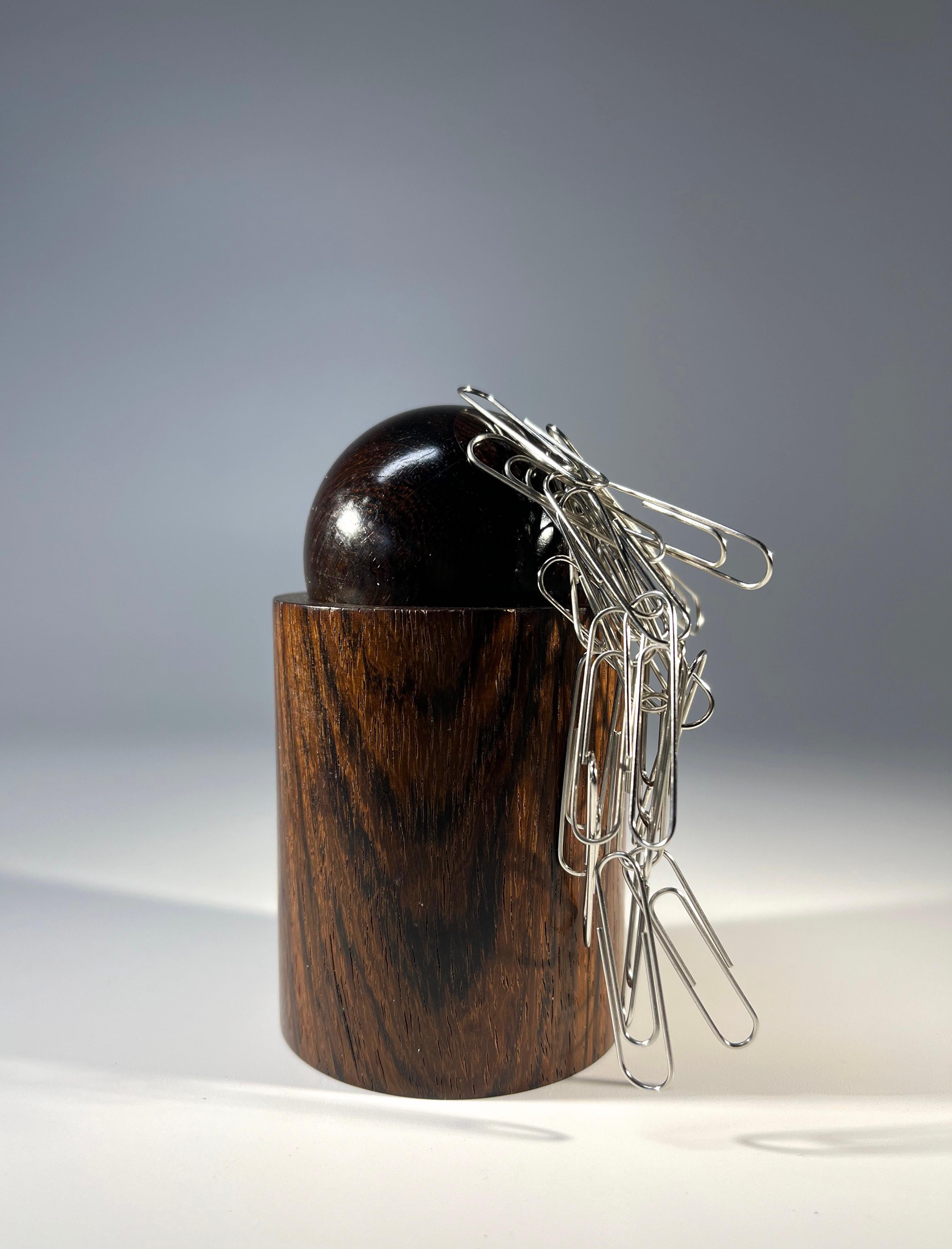Ingenious magnetic paper clip holder designed by Sven Petersen for SAAP, Hillerod, Denmark
Crafted in a rich dark rosewood, the ball of the pot is magnetised to gather paperclips
Scandinavian finest form and function
Circa 1960's
Height 4 inch,