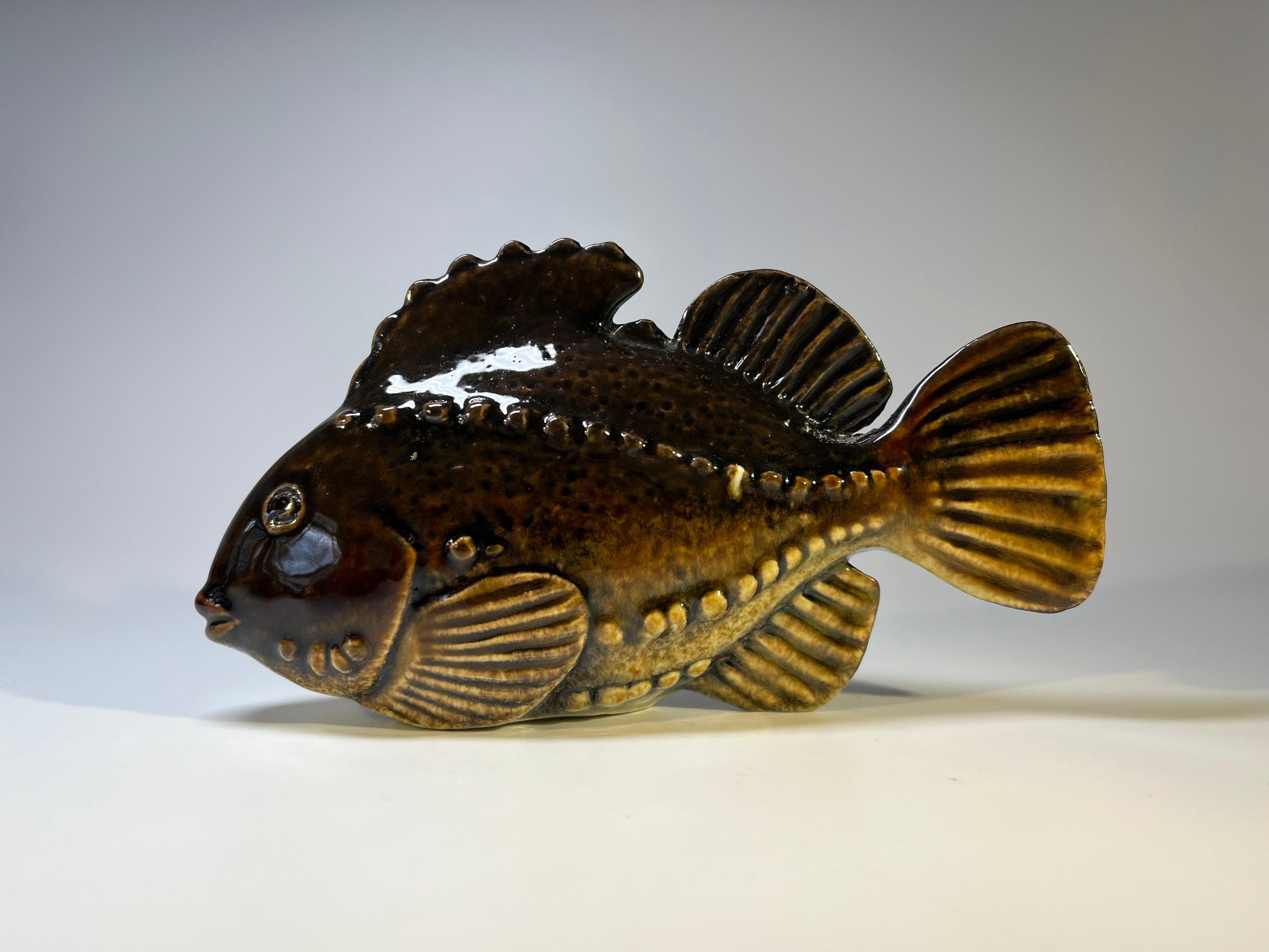 Beautifully glazed stoneware fish figure by Sven Wejsfelt for Gustavsberg, Sweden. Circa 1980's
Rich dark brown glaze
Original Gustavsberg Anchor label attached
Height 3.5 inch, Length 6.5 inch, Width 1.5 inch.
In very good condition.
 