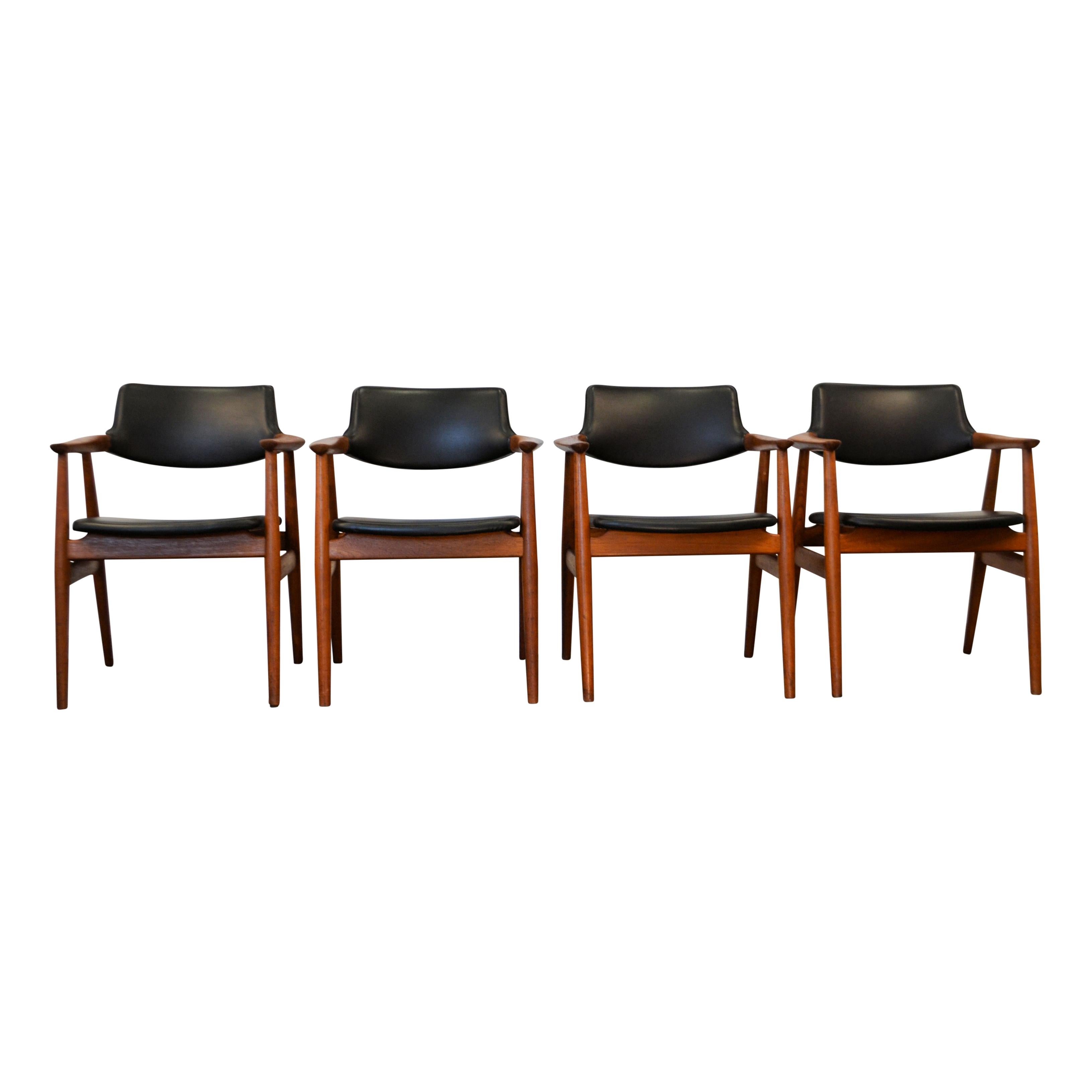 Set of four vintage teak dining chairs with armrests designed by Svend Aage Eriksen for Glostrup Møbelfabrik. These comfortable chairs feature a stylish typical simplistic vintage Danish design. The Skai leather seats complement a variety of