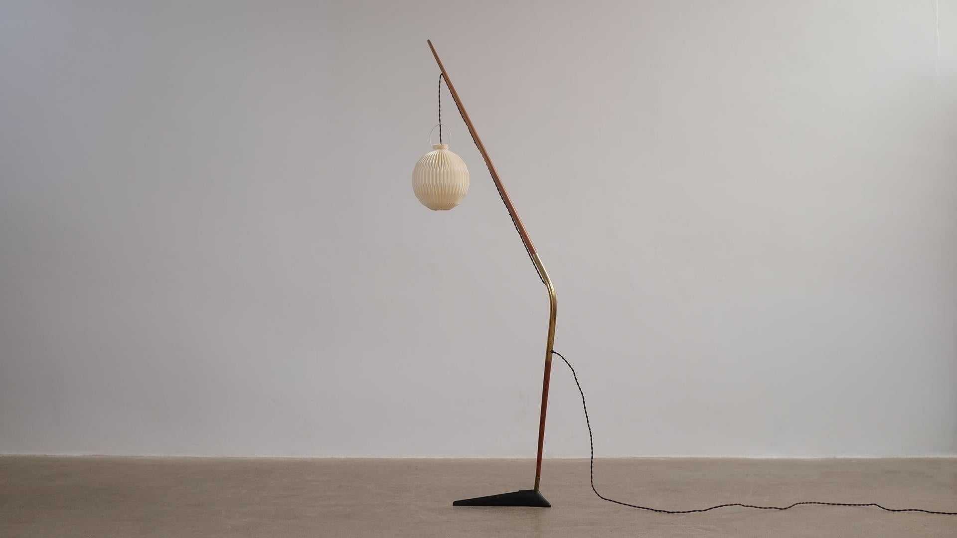 Rare and beautiful 'Fishing Pole' floor light designed by Svend Aage Holm Sorensen for Holm Sorensen and Co, Denmark. Cast iron base with teak and brass shaft. Shade by Le Klint.