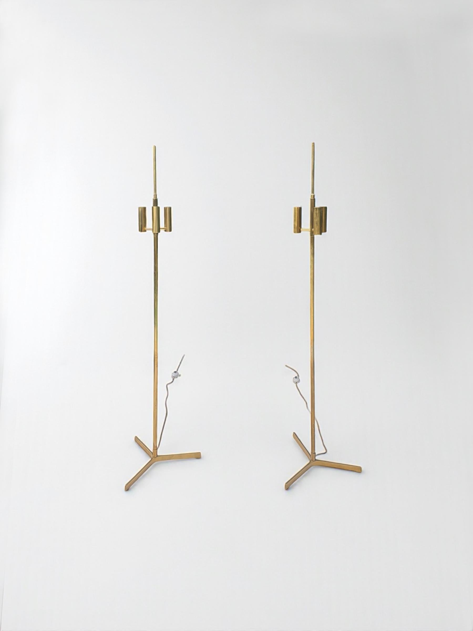 Highly elegant pair of Brass and fabric shade floor lamps, by Svend Aage Holm Sorensen by TH. Valentiner, designed in the 1950's is as contemporary today as it was in the 50's. Beautifully crafted in solid brass each lamp with three light stands