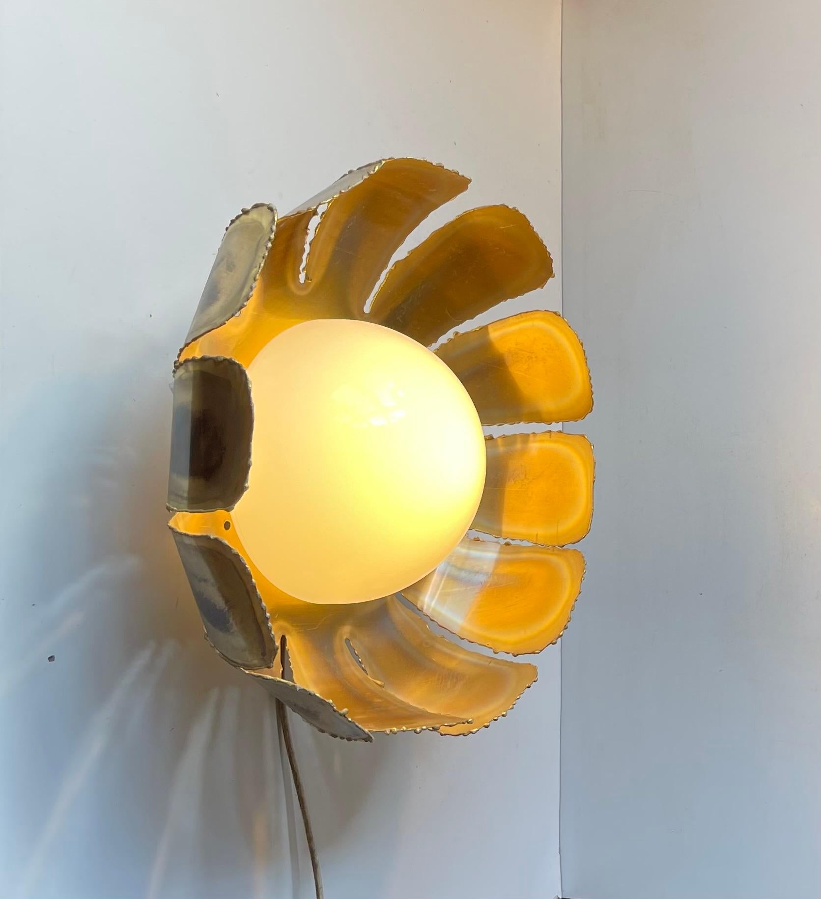 Danish Brutalist sunflower shaped wall sconce or ceiling flush mount. Its made from acid-treated and torch-cut brass featuring a center shade in white opaline glas This rare model was designed by Svend Aage Holm Sorensen in the early 1960s. A great